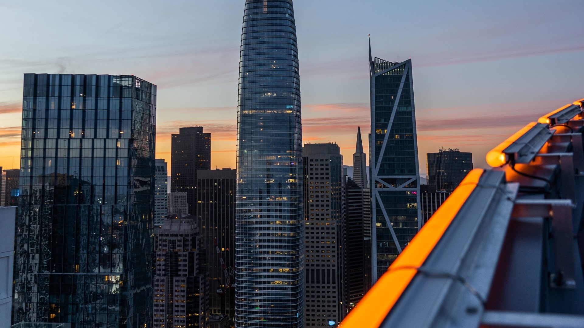 Skyscrapers at sunset with orange lights HD Wallpaper