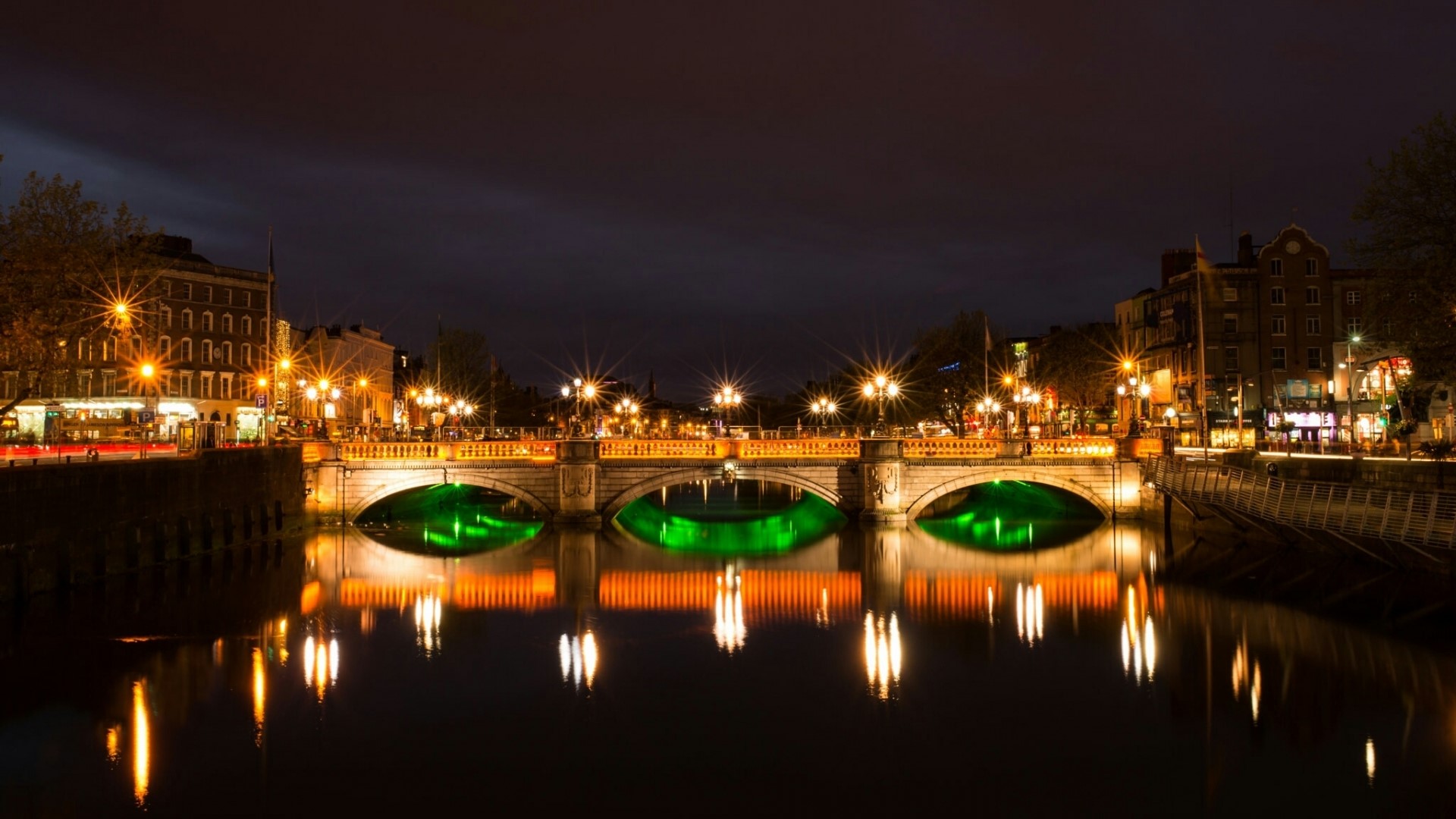 Bridge over river at night with reflections HD Wallpaper