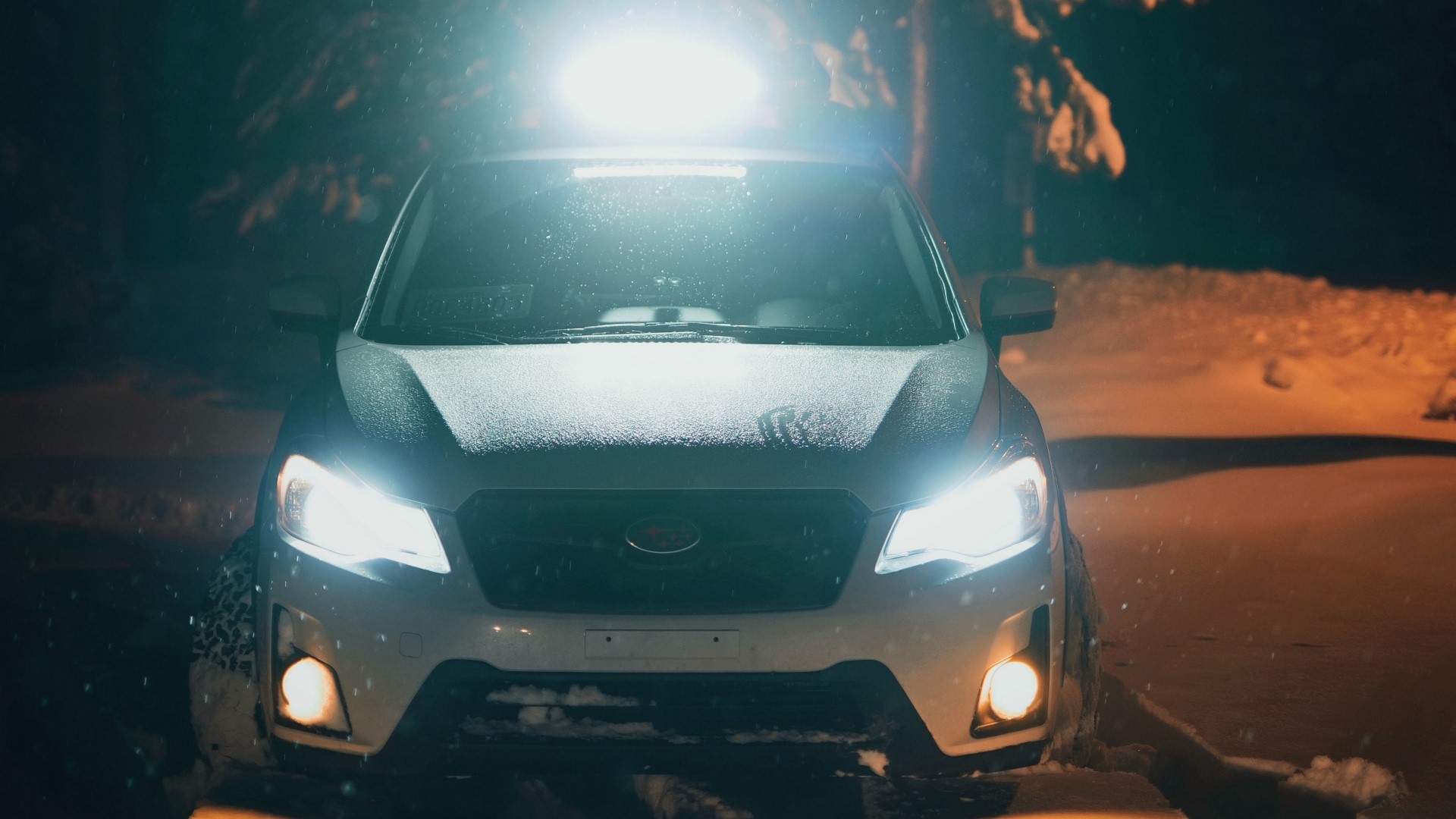 White Subaru Forester with light bar in snow at night HD Wallpaper