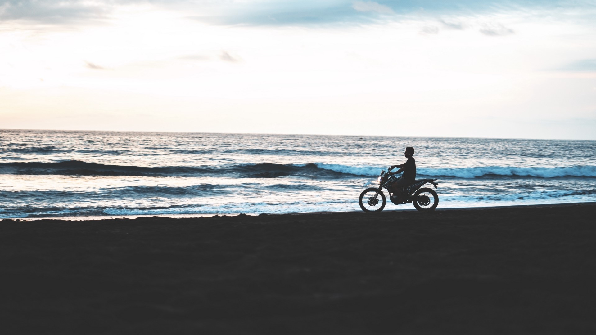 Motorcyclist on a Beach at Sunset HD Wallpaper