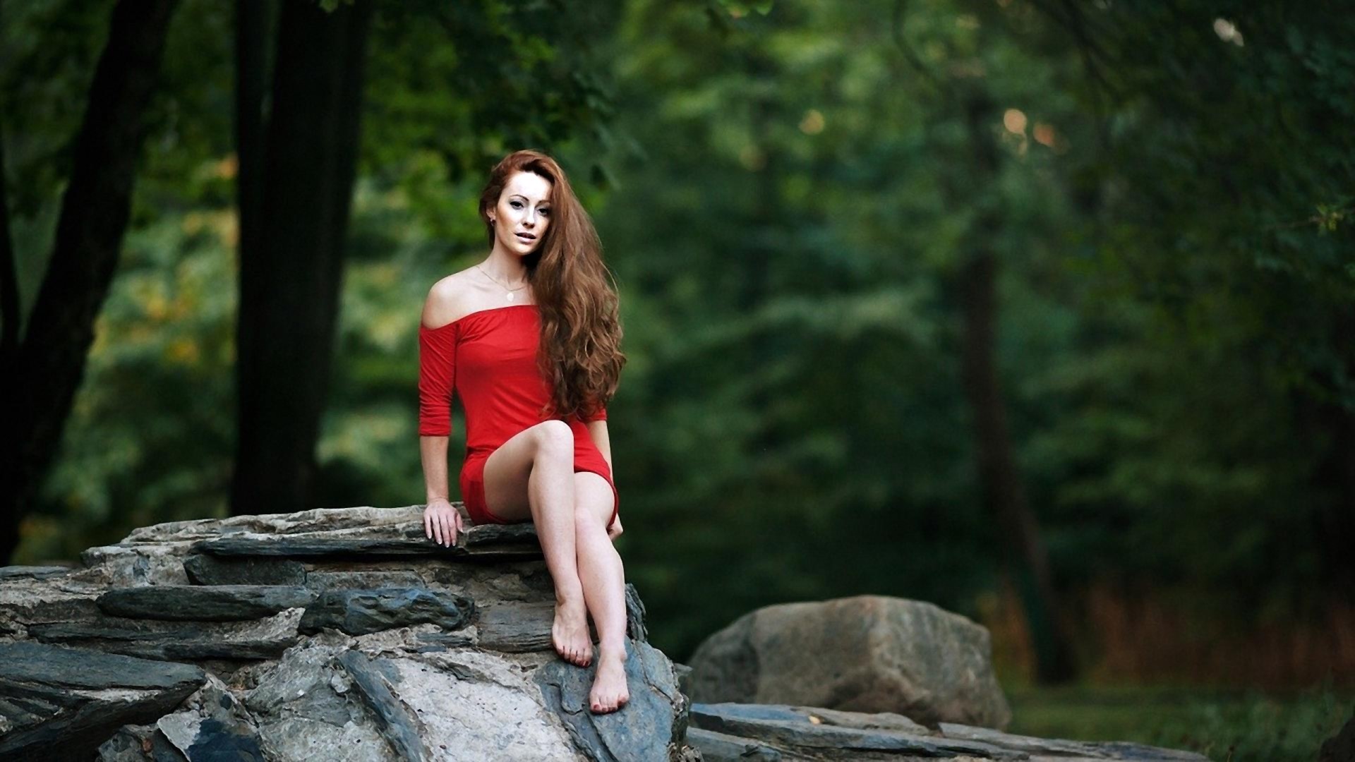 Woman in red dress sitting on rocks HD Wallpaper