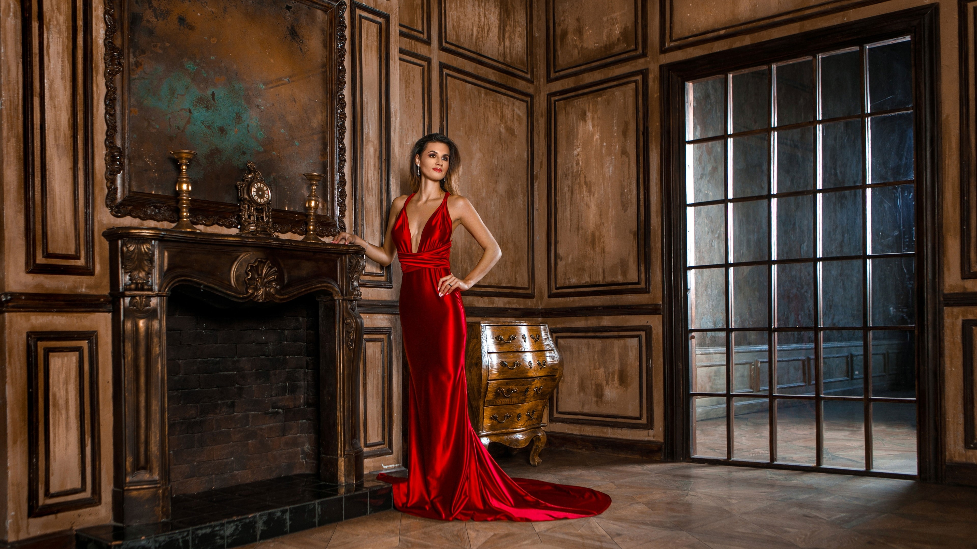 Woman in red dress by fireplace HD Wallpaper