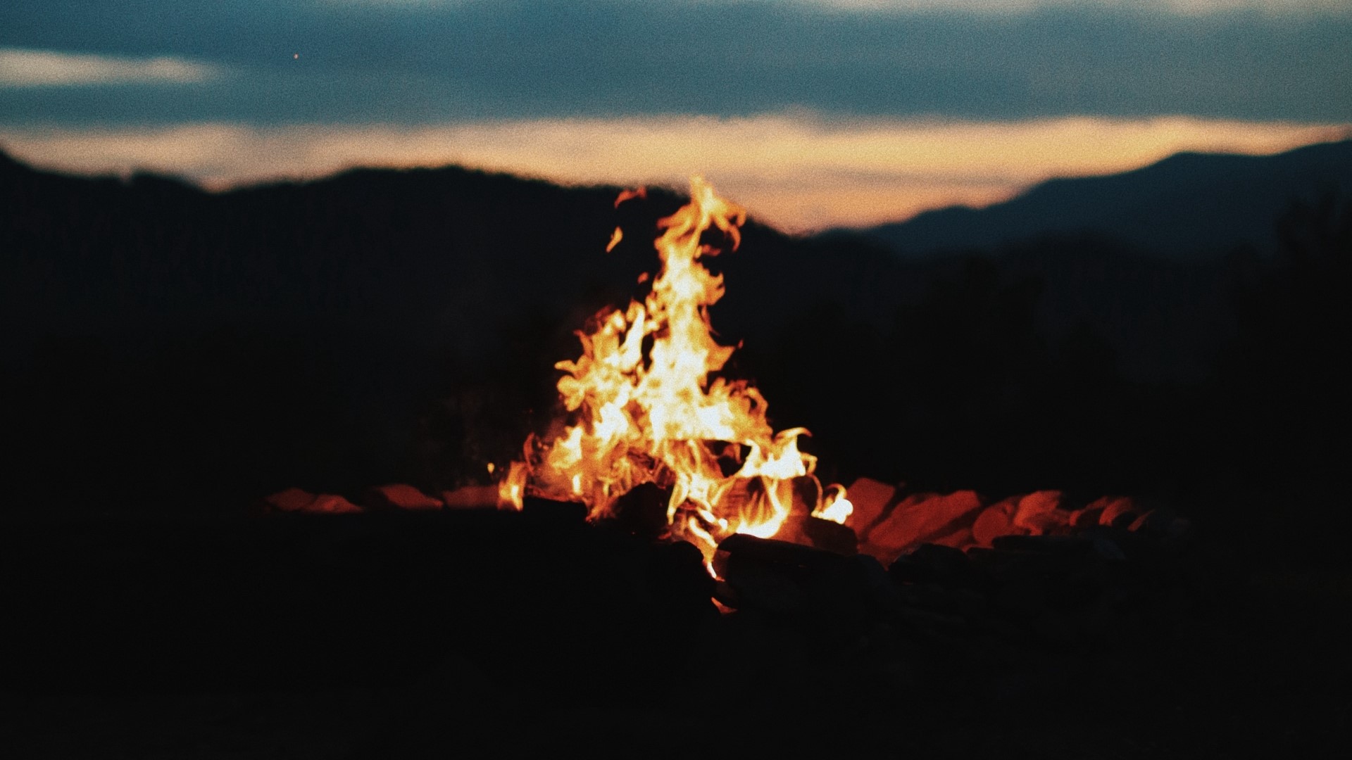 Bonfire at dusk with mountains HD Wallpaper