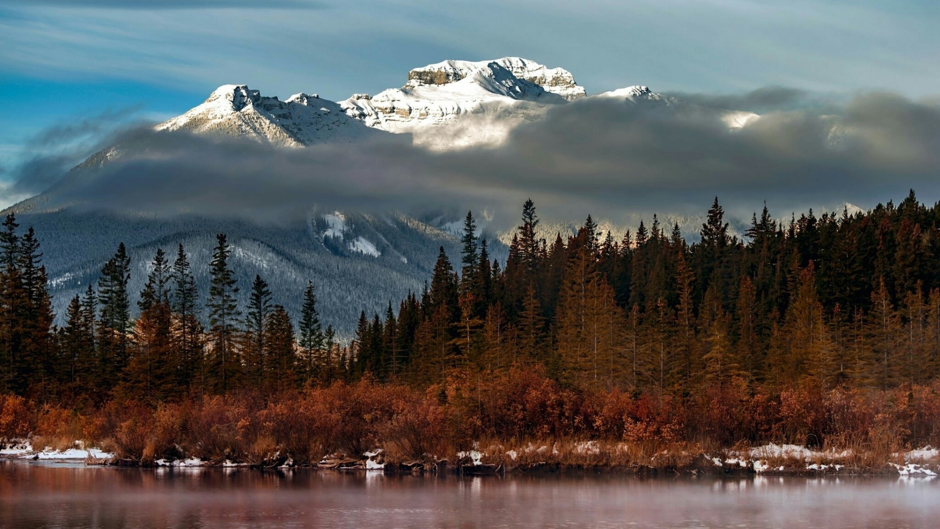 Snow-capped mountain behind a forest and lake HD Wallpaper
