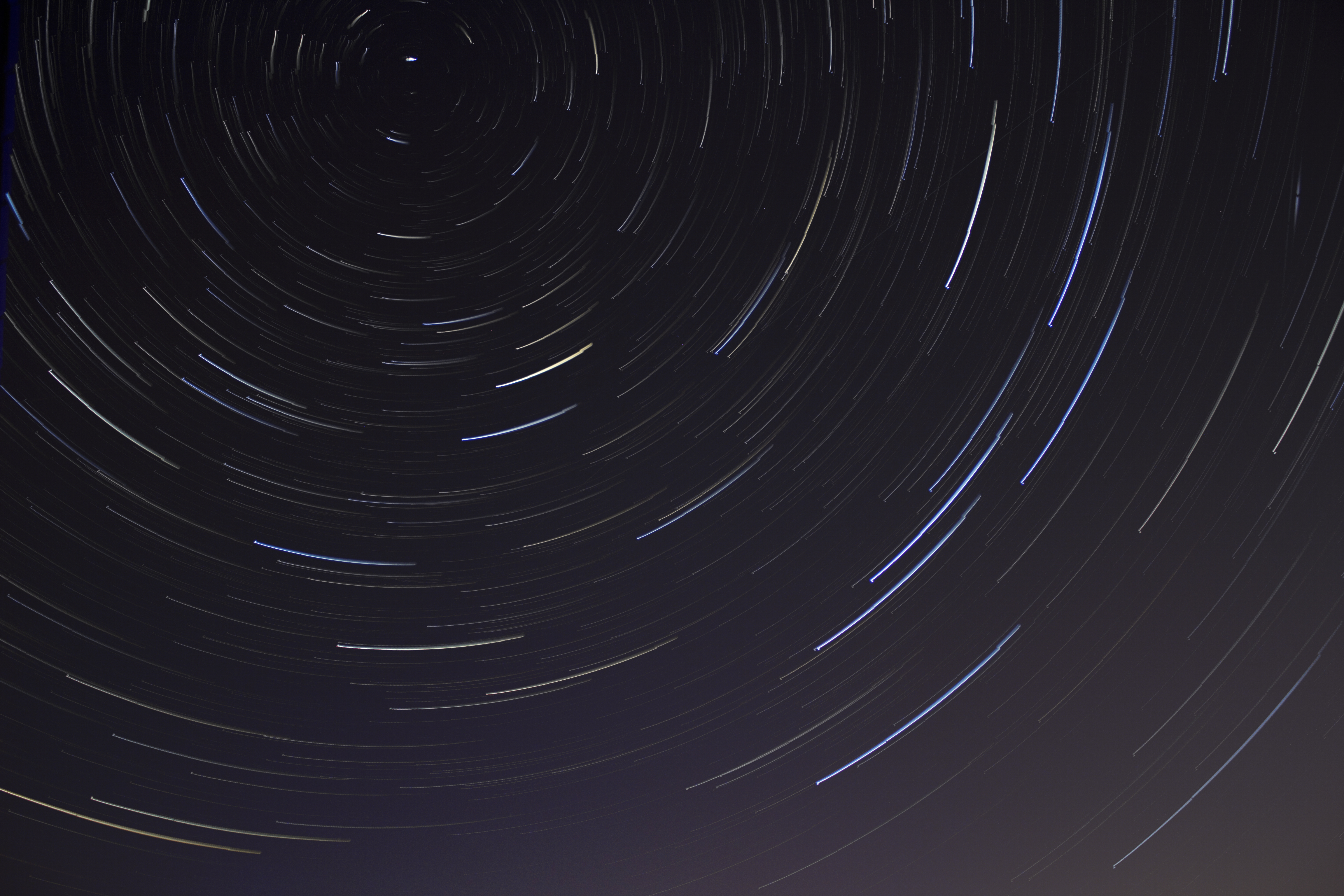 Star trails in the night sky HD Wallpaper