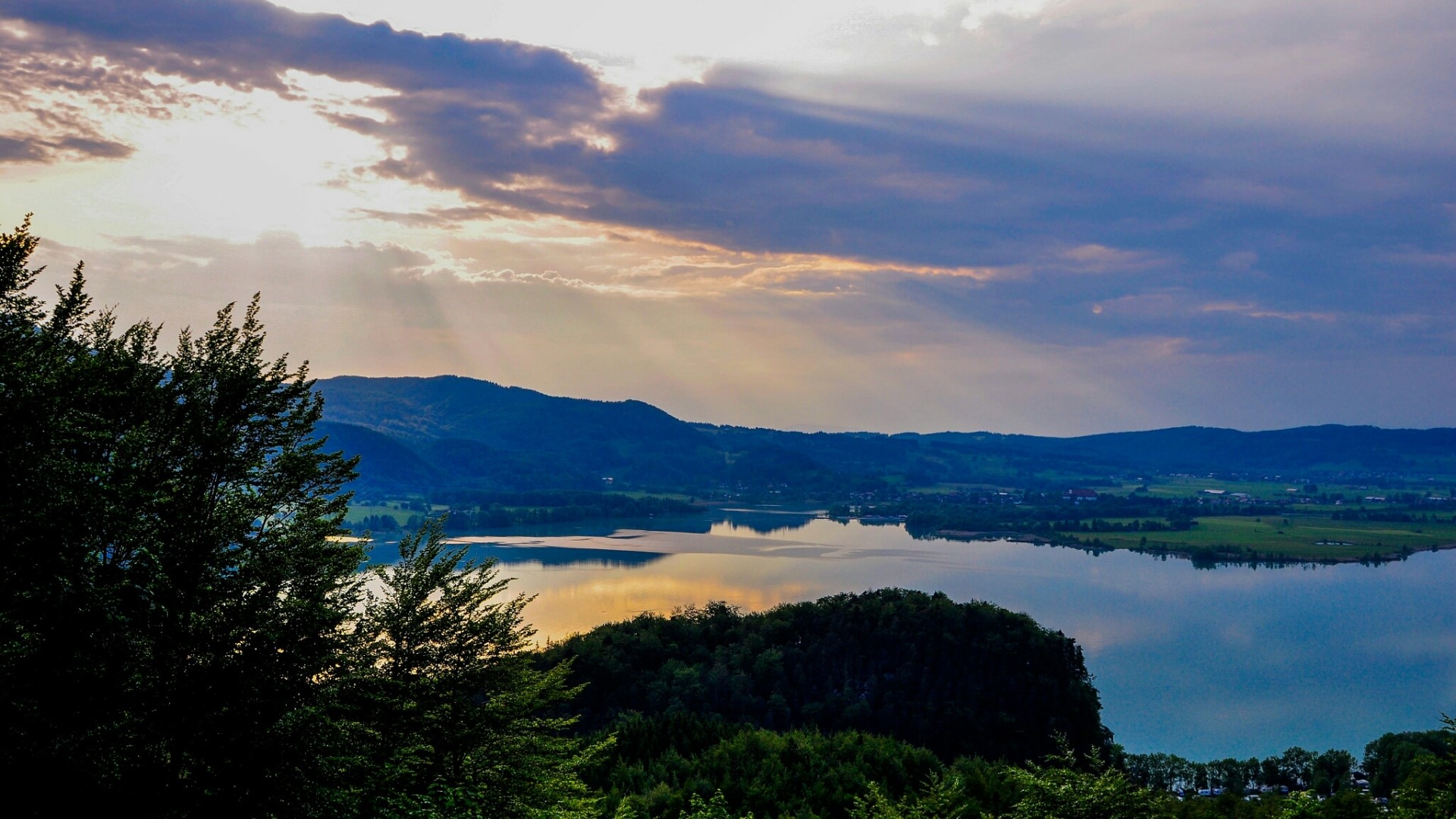 Sunbeams over a lake and mountains HD Wallpaper