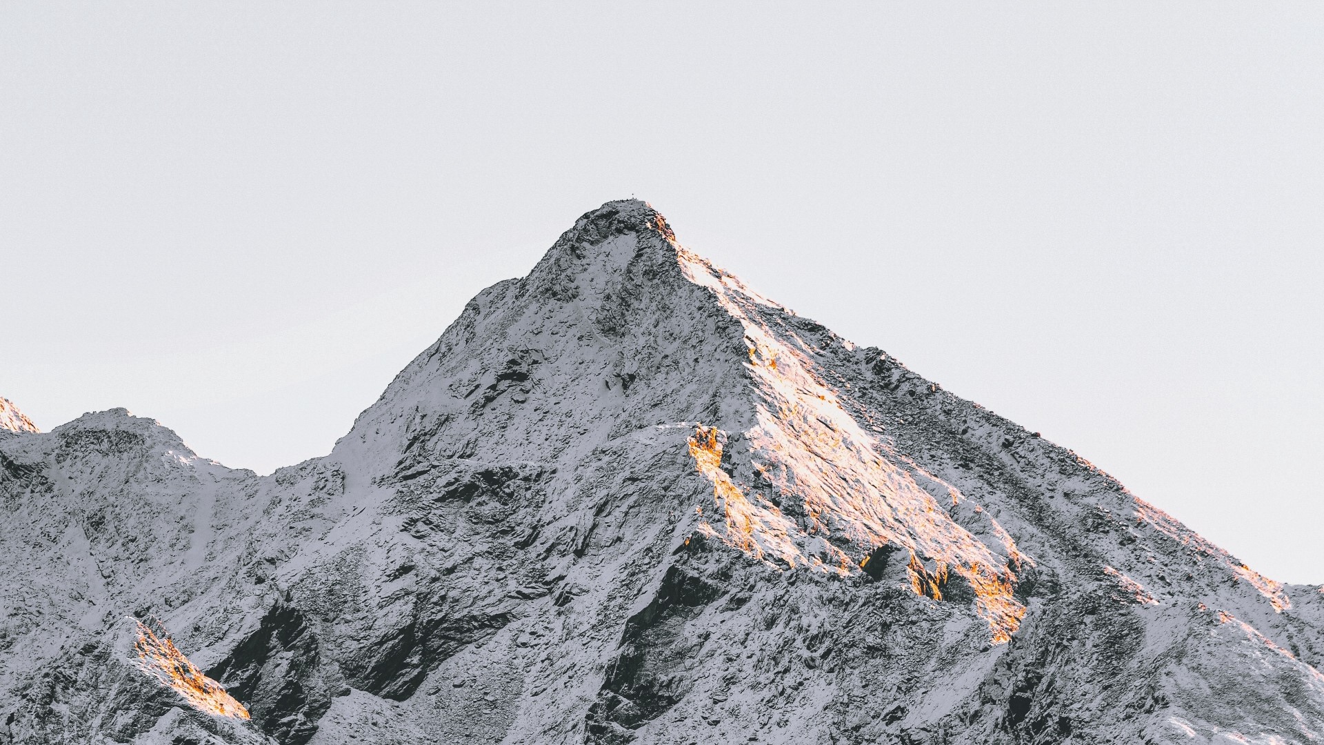 Snow-covered mountain peak against a clear sky HD Wallpaper