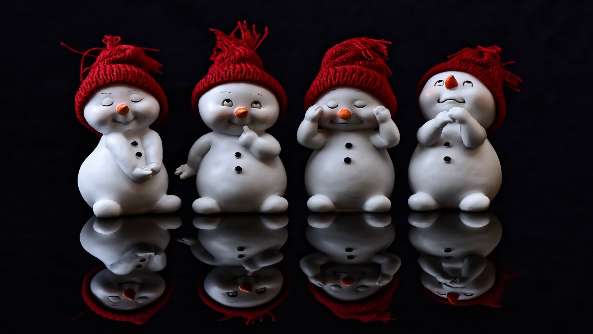 Four Snowmen with Red Hats HD Wallpaper