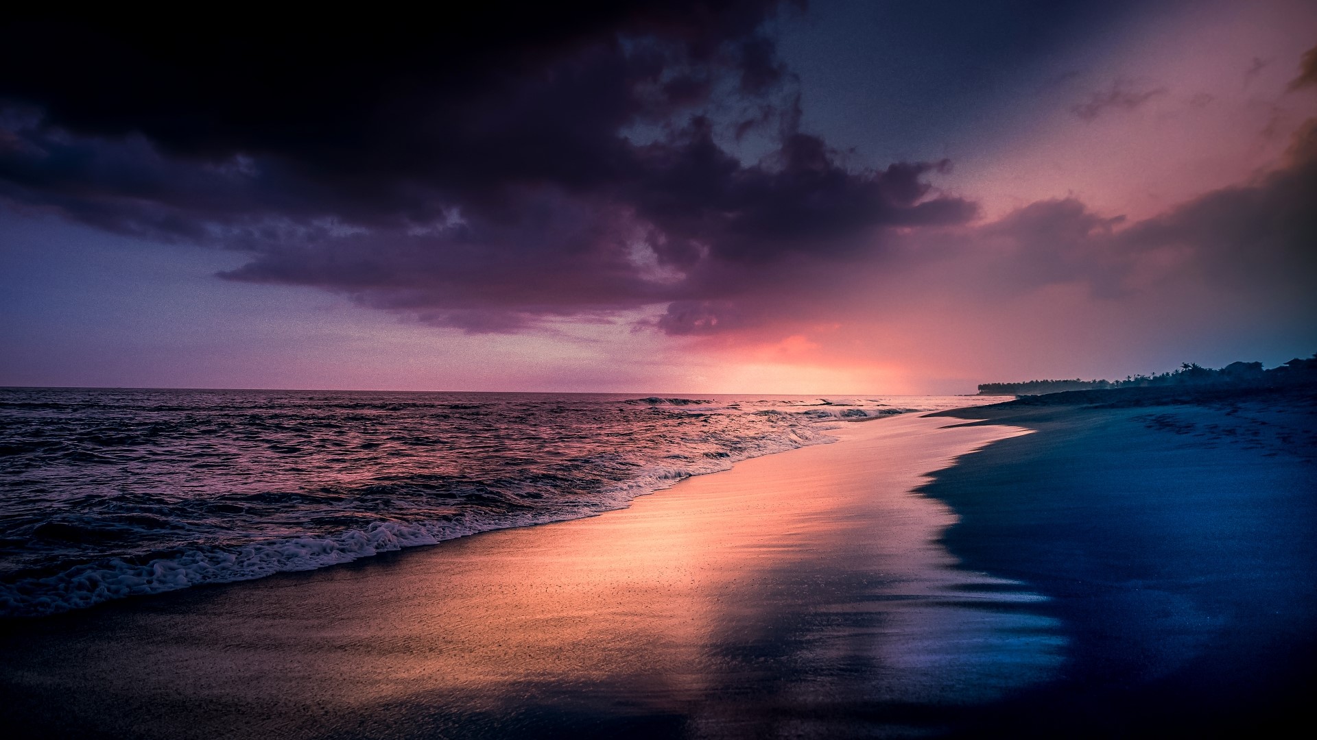 Sunset over a tropical beach with dark clouds HD Wallpaper