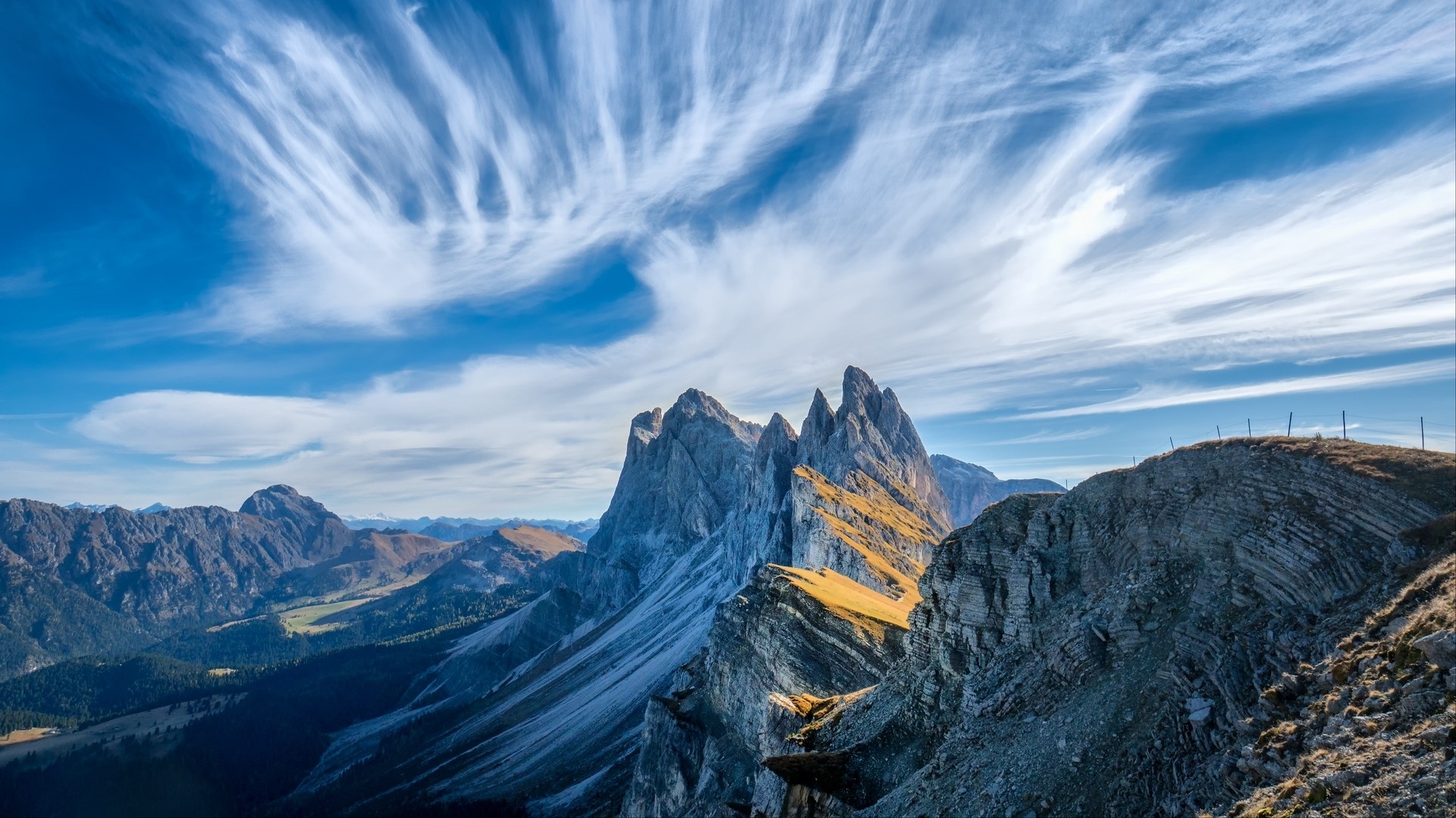 Dramatic mountain peaks under a wispy sky HD Wallpaper