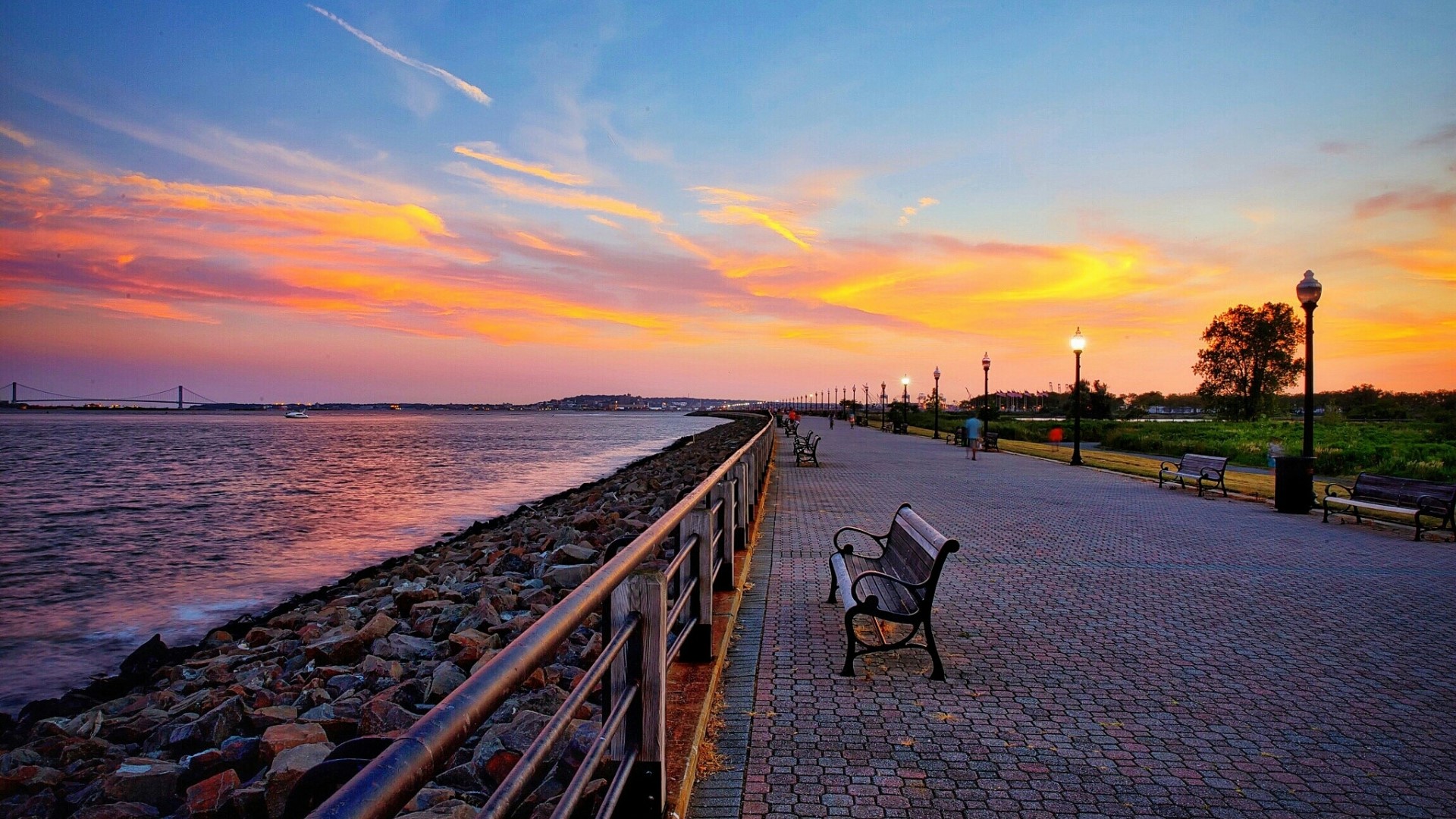 Boardwalk at sunset with ocean and bridge HD Wallpaper