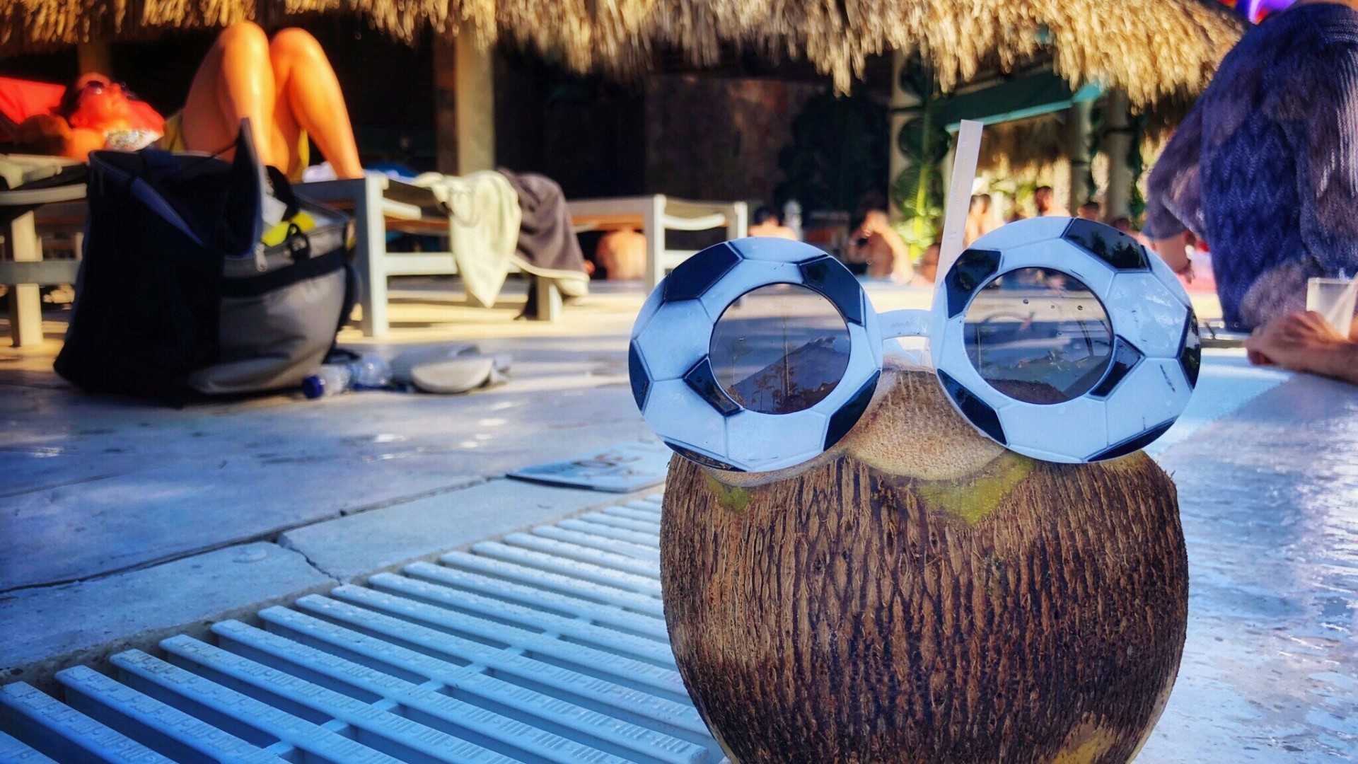 Coconut with soccer ball sunglasses by pool HD Wallpaper