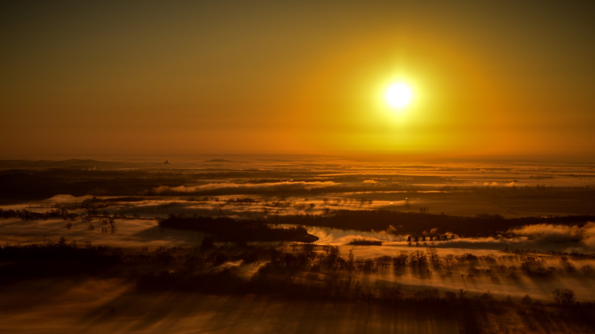Sunset over misty landscape HD Wallpaper