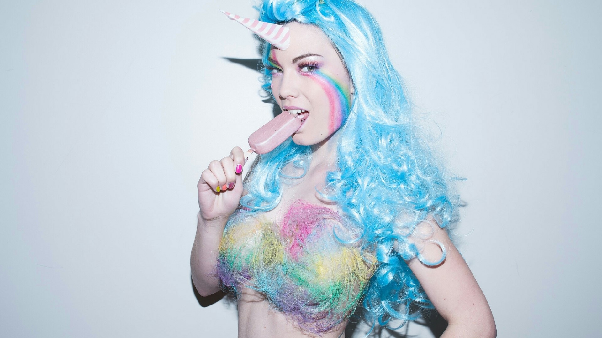 Woman with blue wig and unicorn horn eating popsicle HD Wallpaper