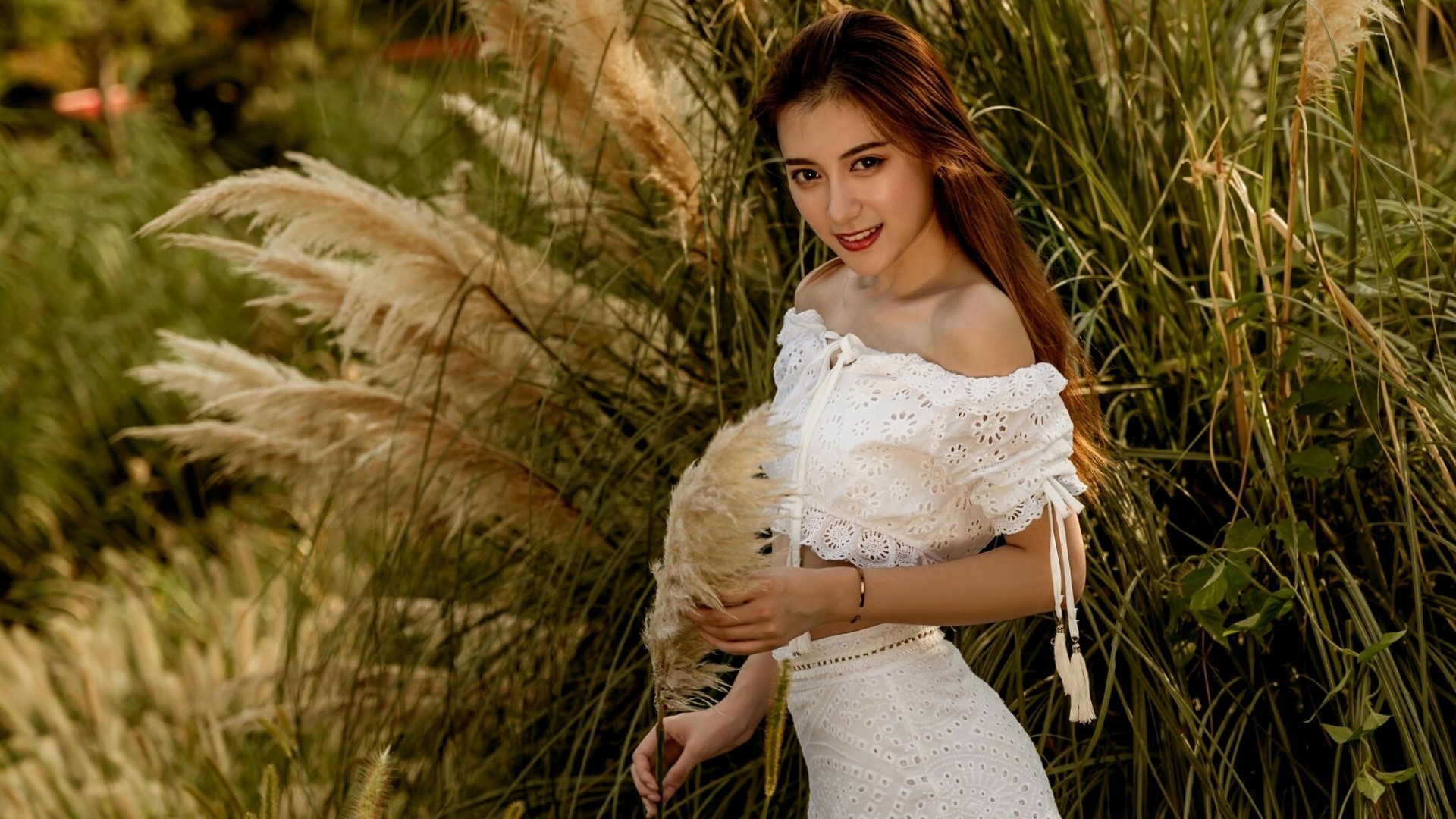 Young woman in white dress among tall grasses HD Wallpaper