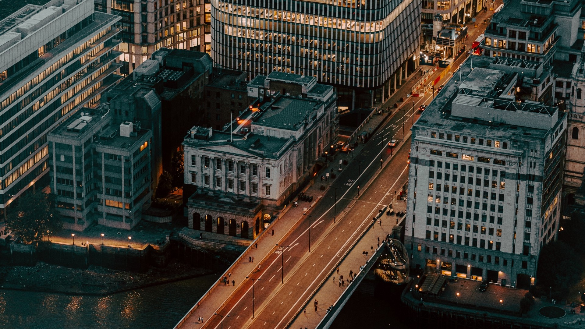 Aerial view of a city bridge and buildings at night HD Wallpaper