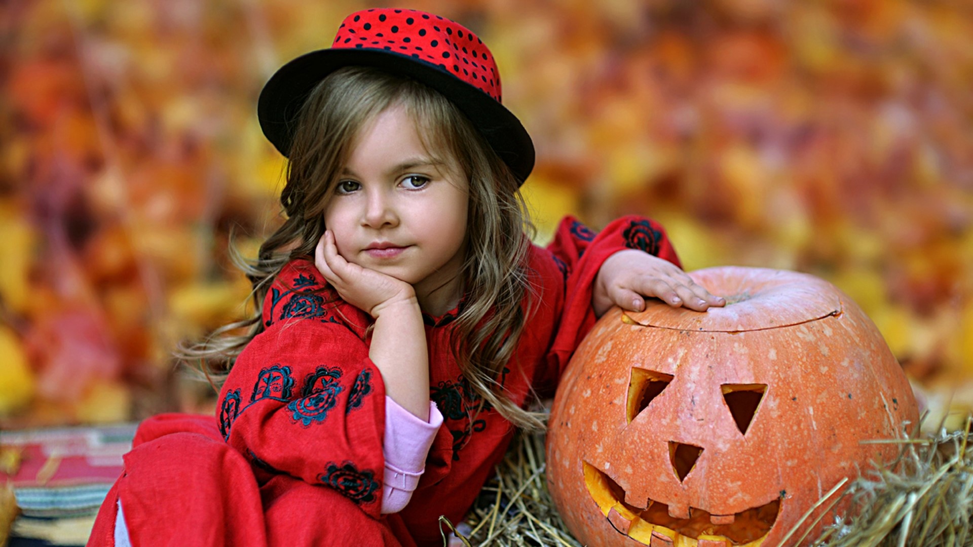 Girl in Halloween costume with carved pumpkin HD Wallpaper