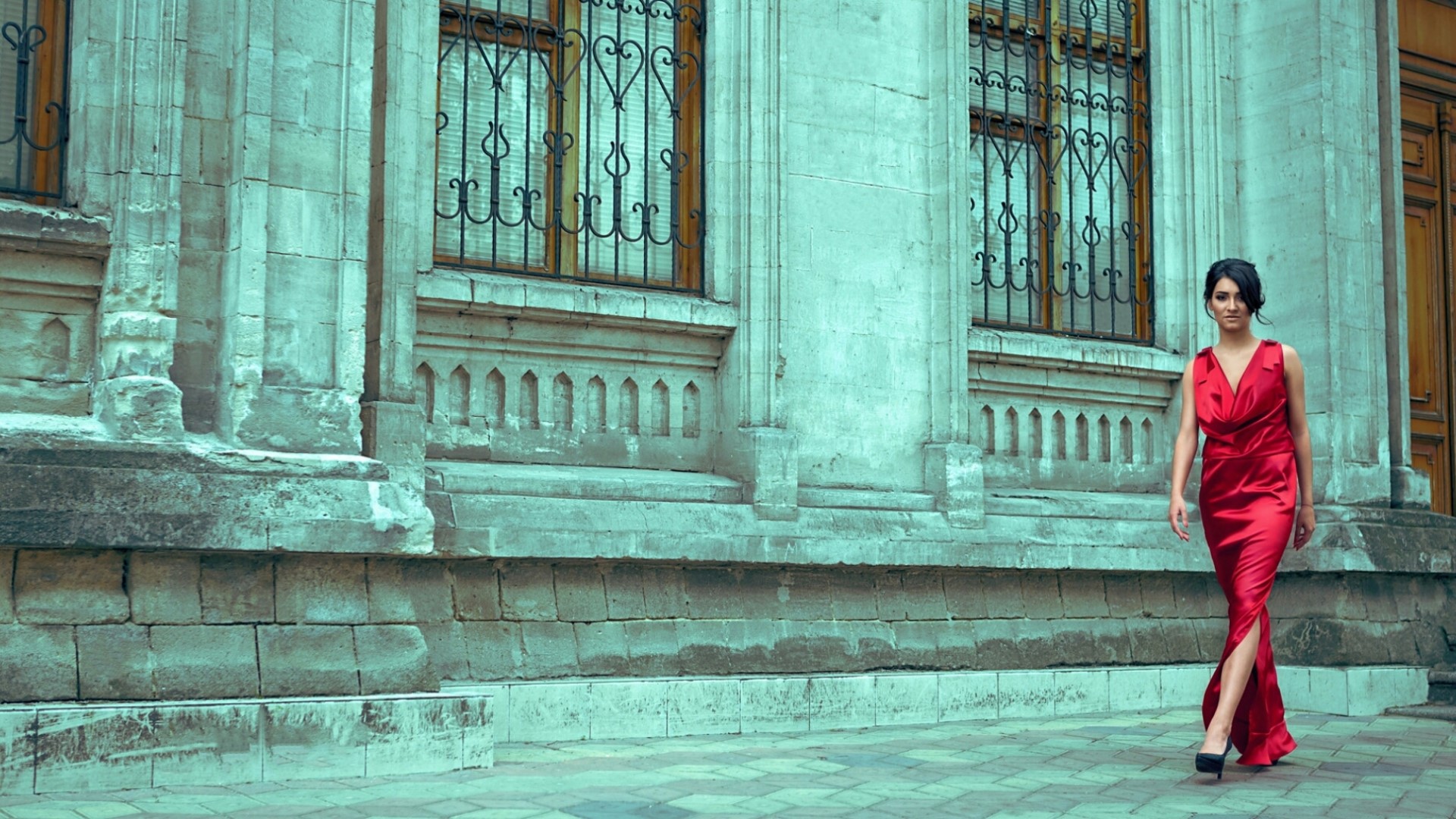 Woman in red dress walking by a building HD Wallpaper