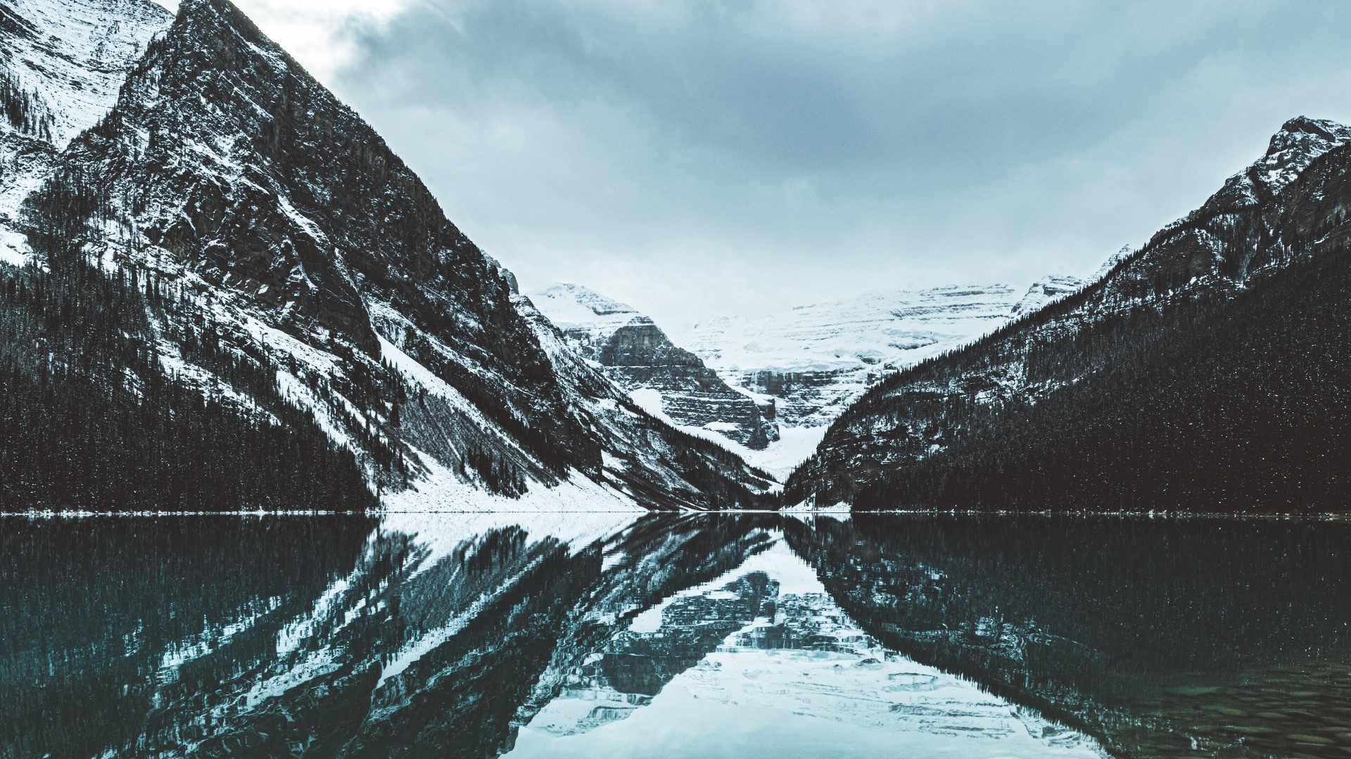 Snow-capped mountains reflected in a lake HD Wallpaper