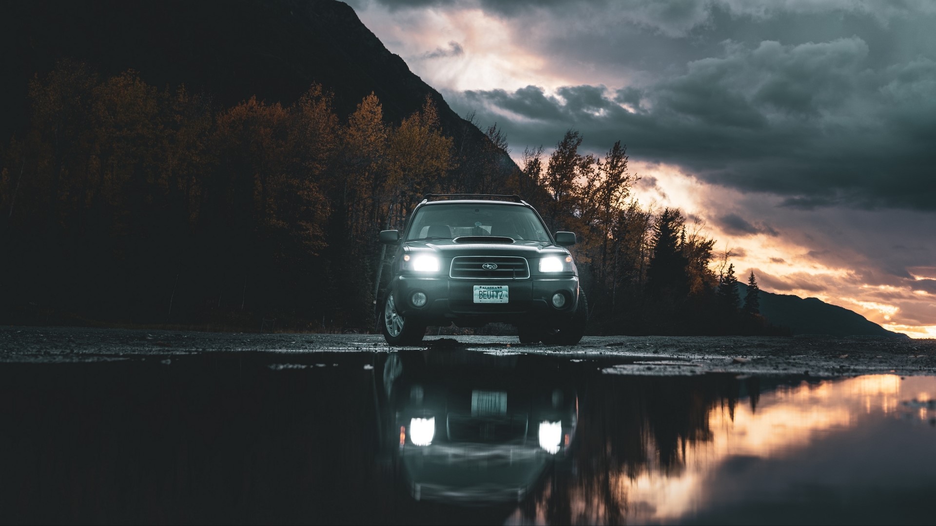 Subaru Forester SUV parked by a lake at sunset HD Wallpaper