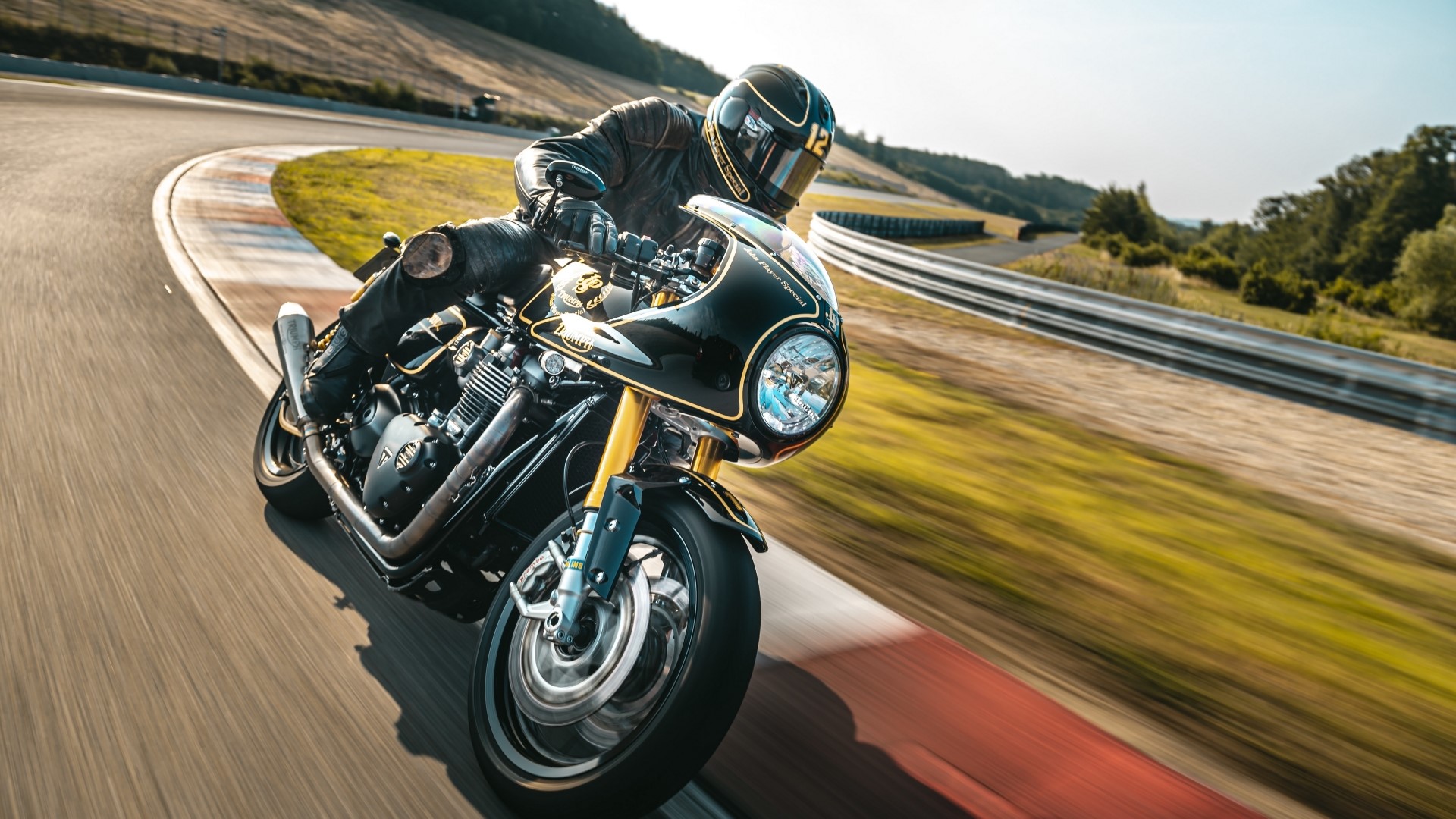 Motorcyclist on a black and gold sportbike on a race track HD Wallpaper