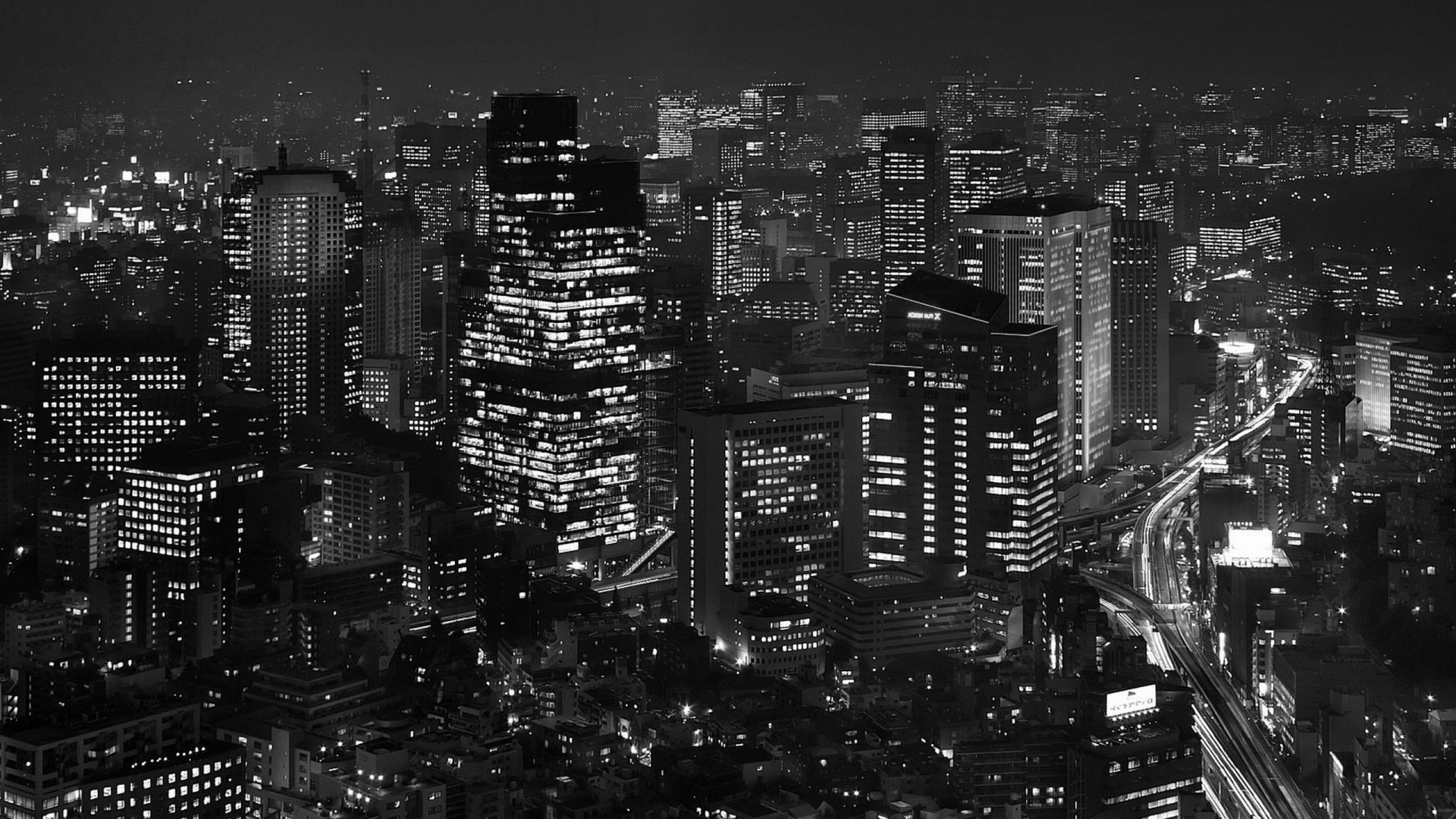 Night cityscape with illuminated skyscrapers and highways HD Wallpaper