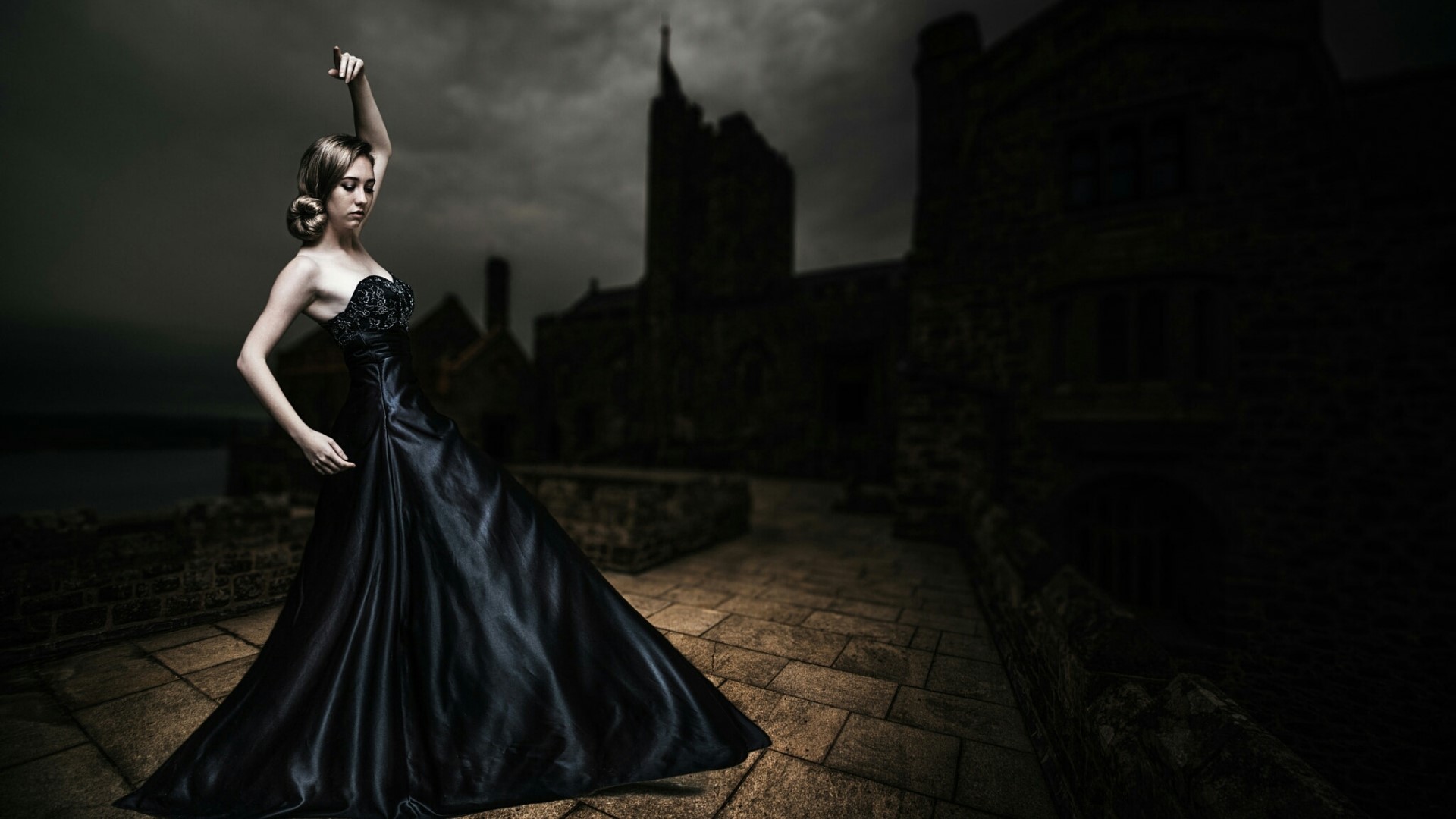 Woman in black dress in front of castle HD Wallpaper