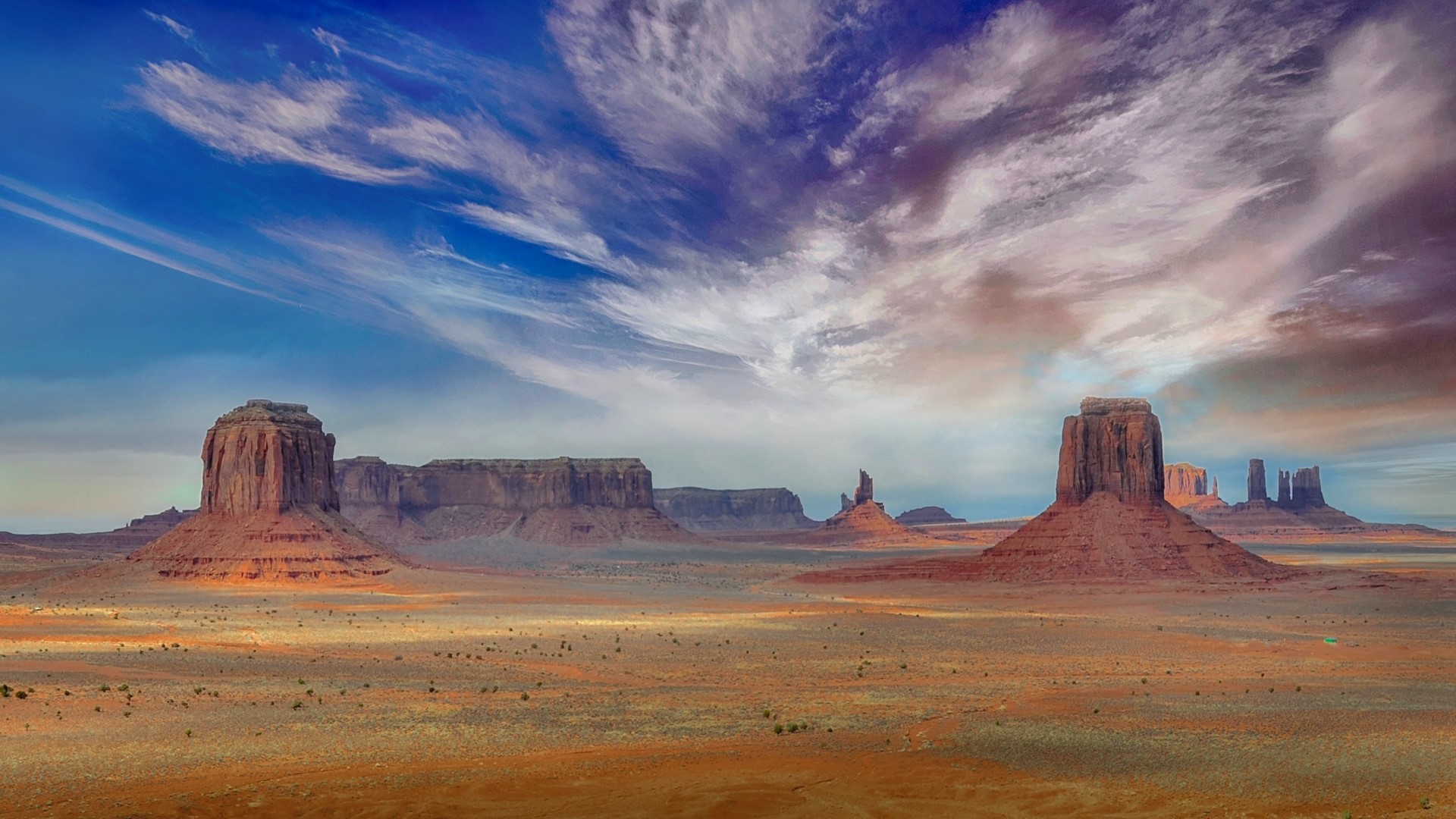 Monument Valley desert landscape with mesas and clouds HD Wallpaper