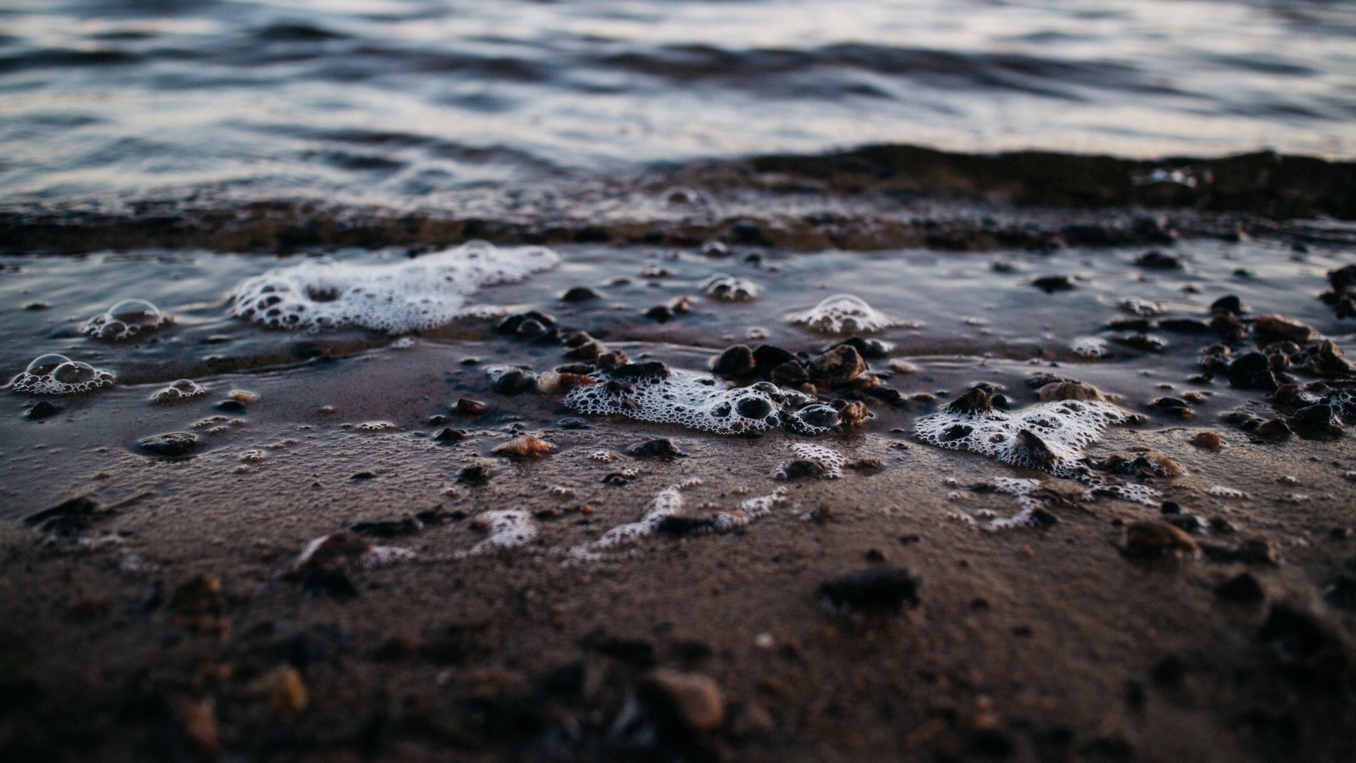 Close-up of a beach with waves and pebbles HD Wallpaper