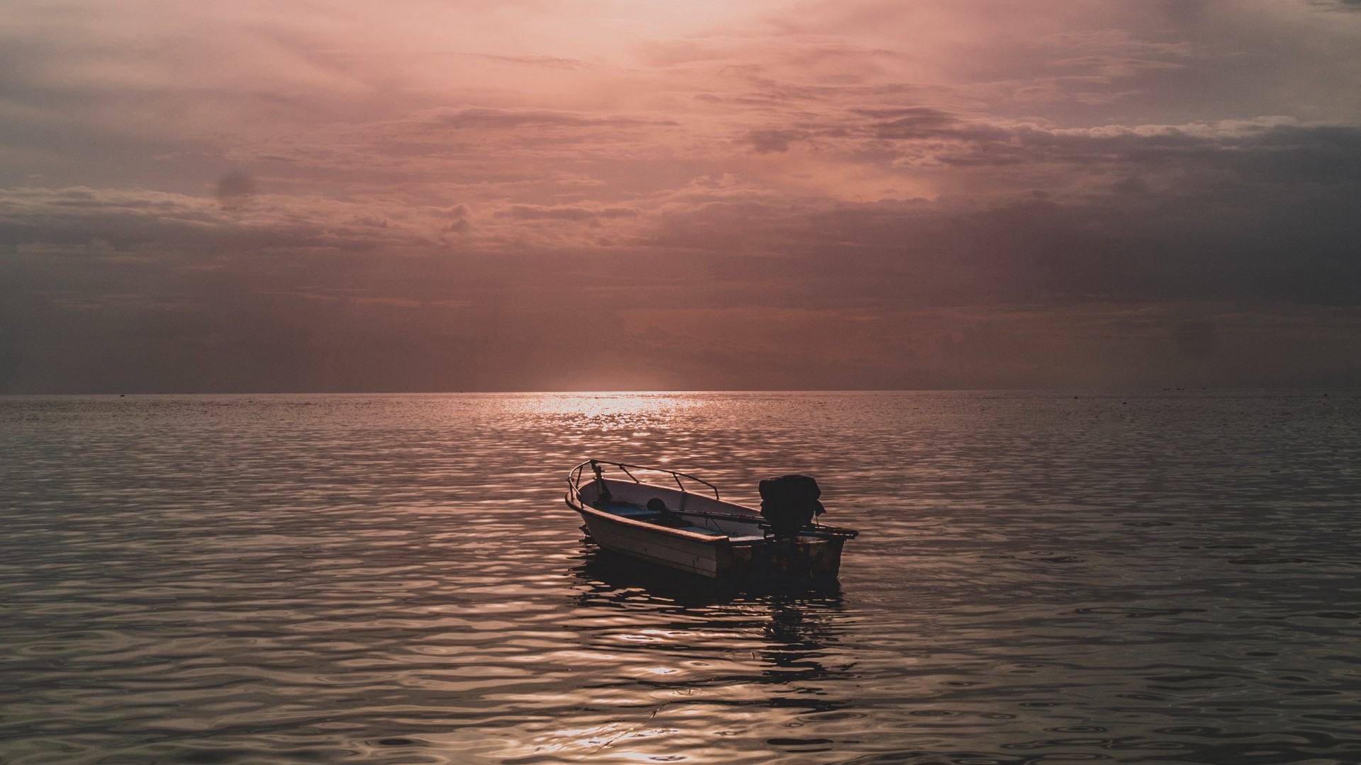 A boat on the water at sunset HD Wallpaper
