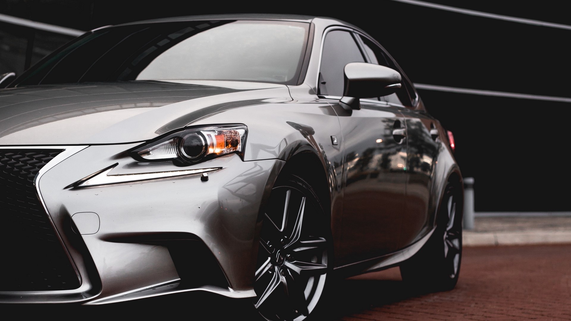 Lexus IS sedan parked on brick pavement HD Wallpaper