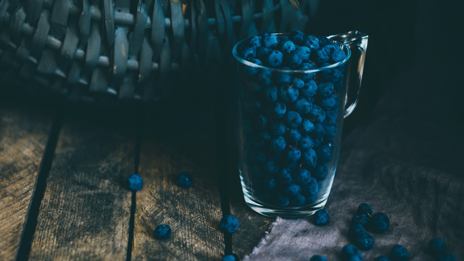 Blueberries in a glass pitcher on a wooden table HD Wallpaper