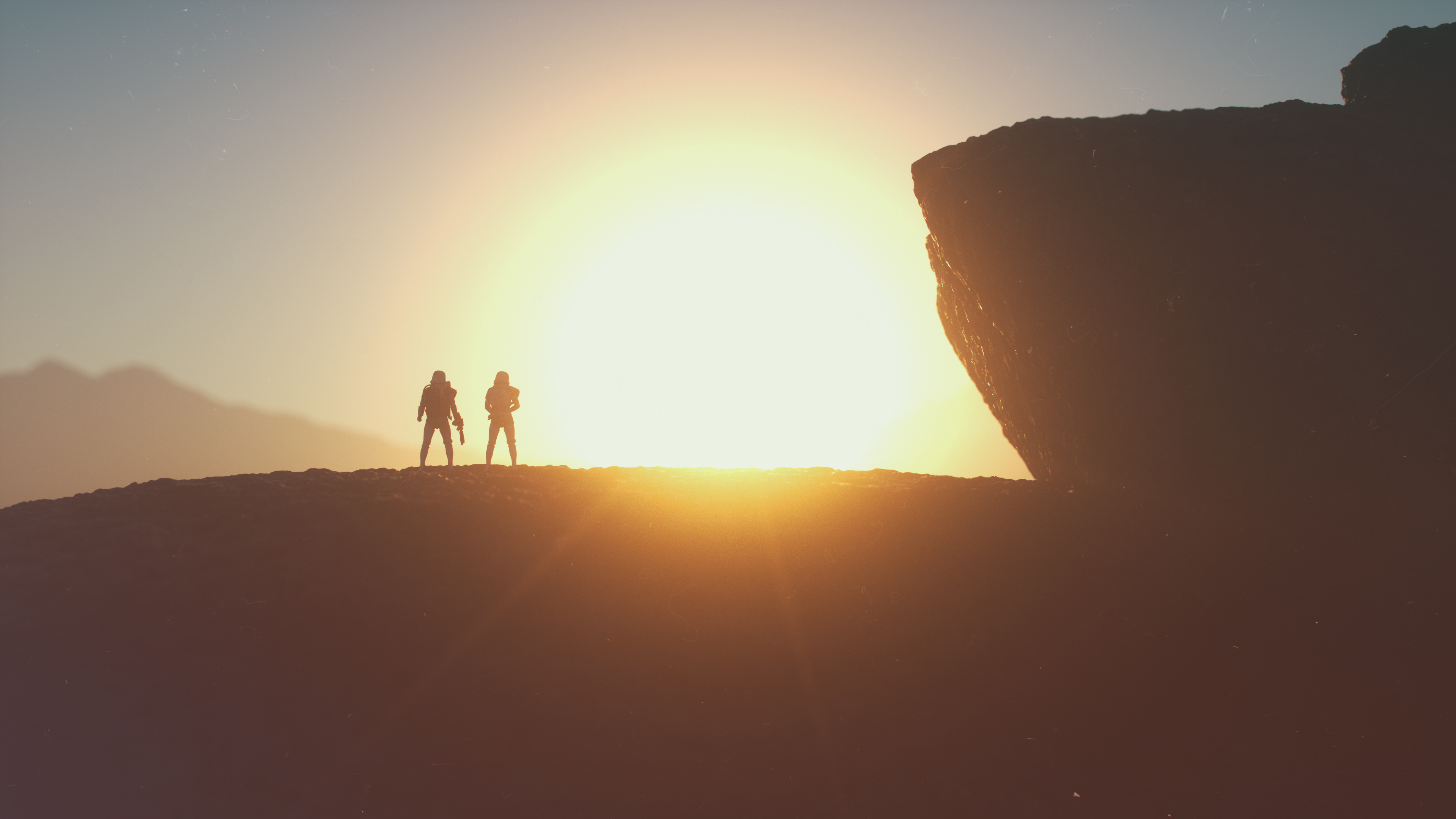Two Stormtroopers silhouetted against a sunset on a rocky planet HD Wallpaper