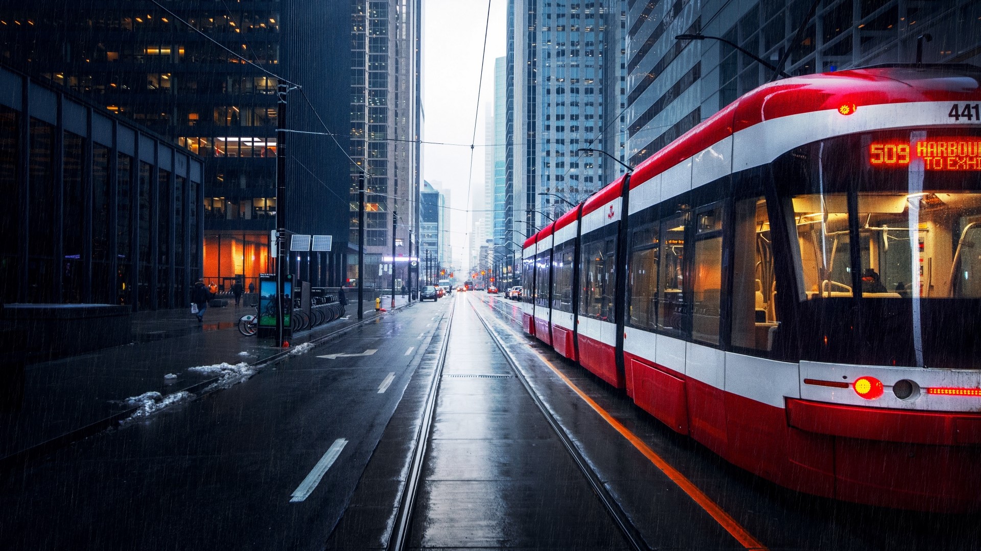 Red streetcar on a rainy city street HD Wallpaper