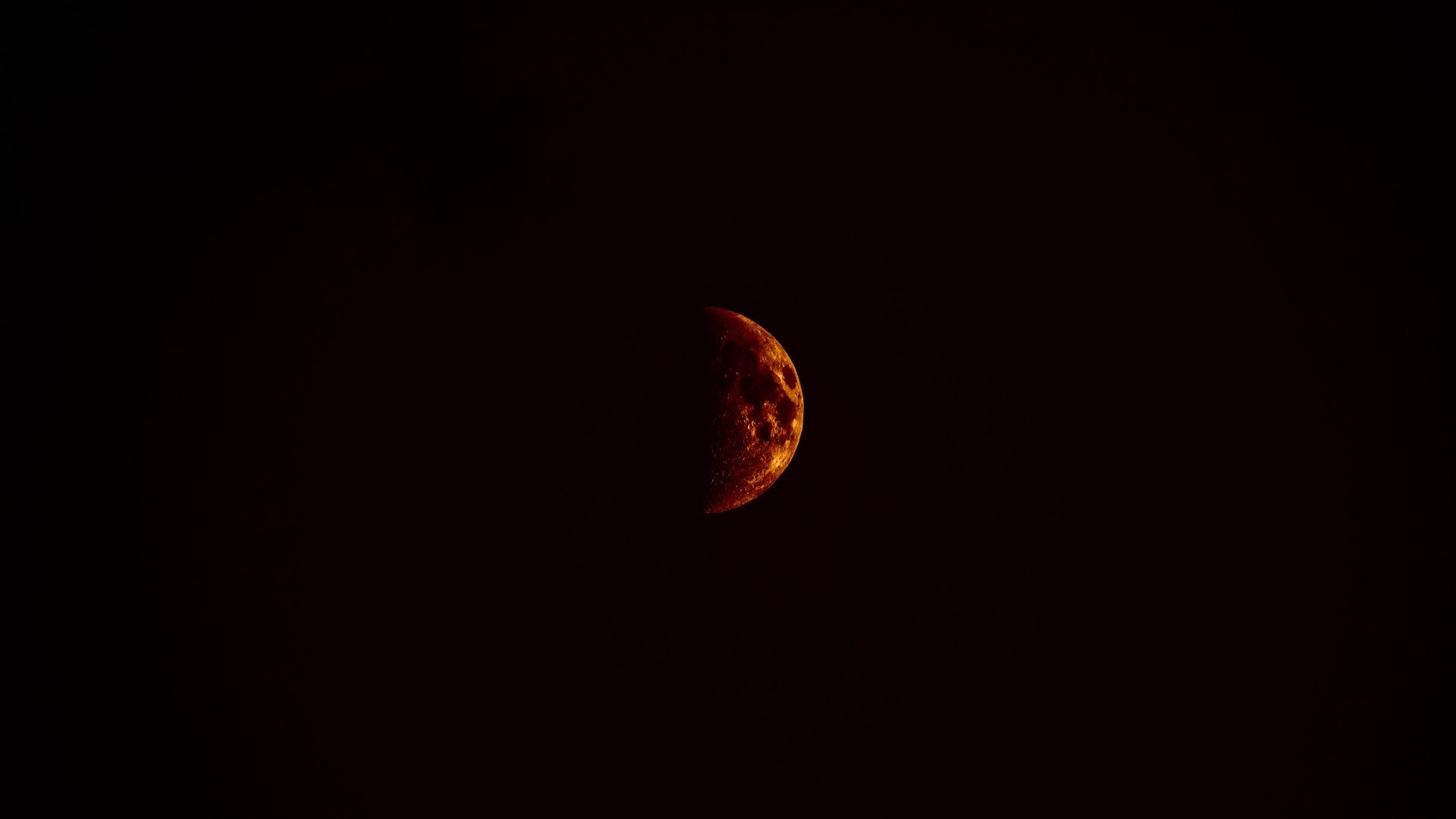 Half illuminated moon in dark sky HD Wallpaper