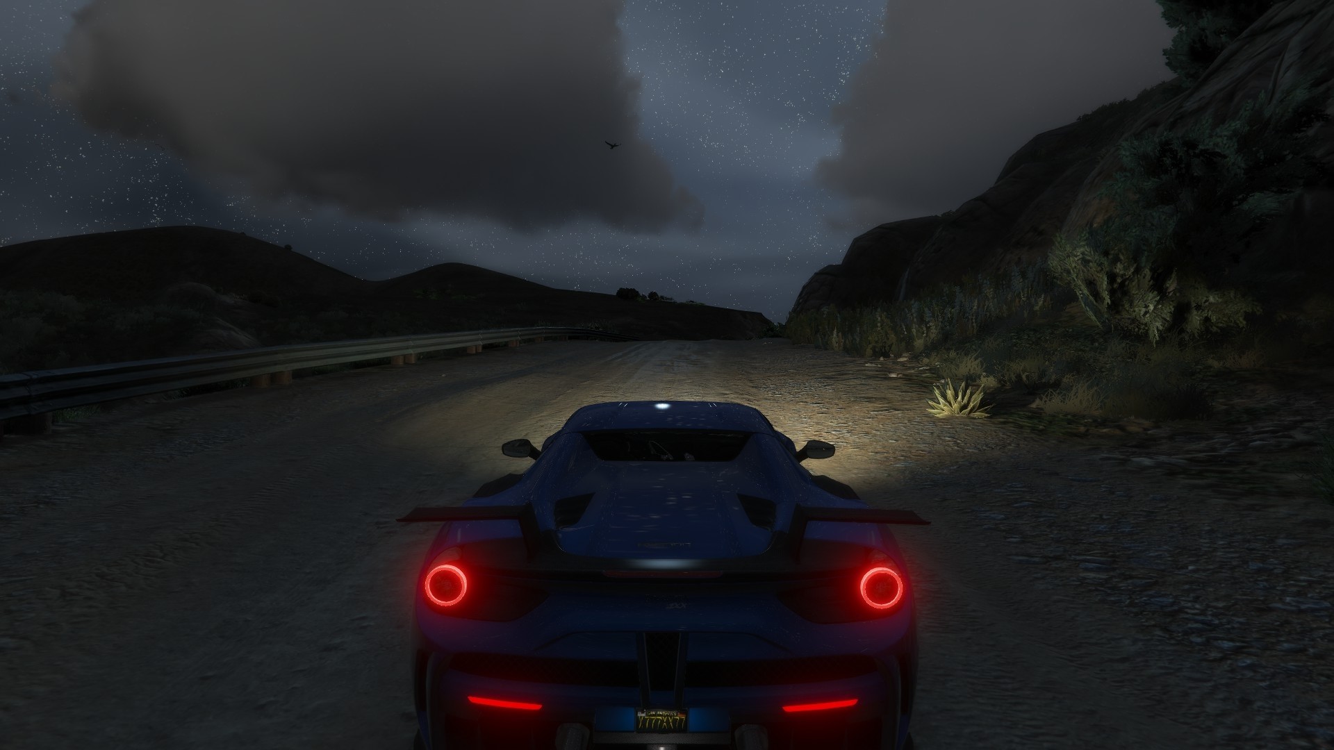 Blue Ferrari driving on a dirt road at night HD Wallpaper