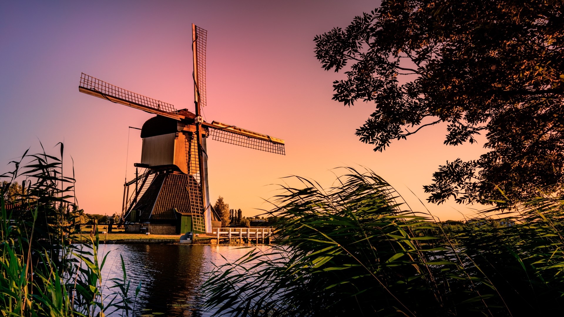 Windmill by the water at sunset HD Wallpaper