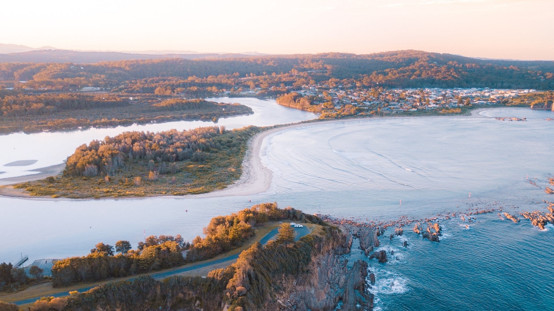 Coastal landscape with river and town at sunset HD Wallpaper