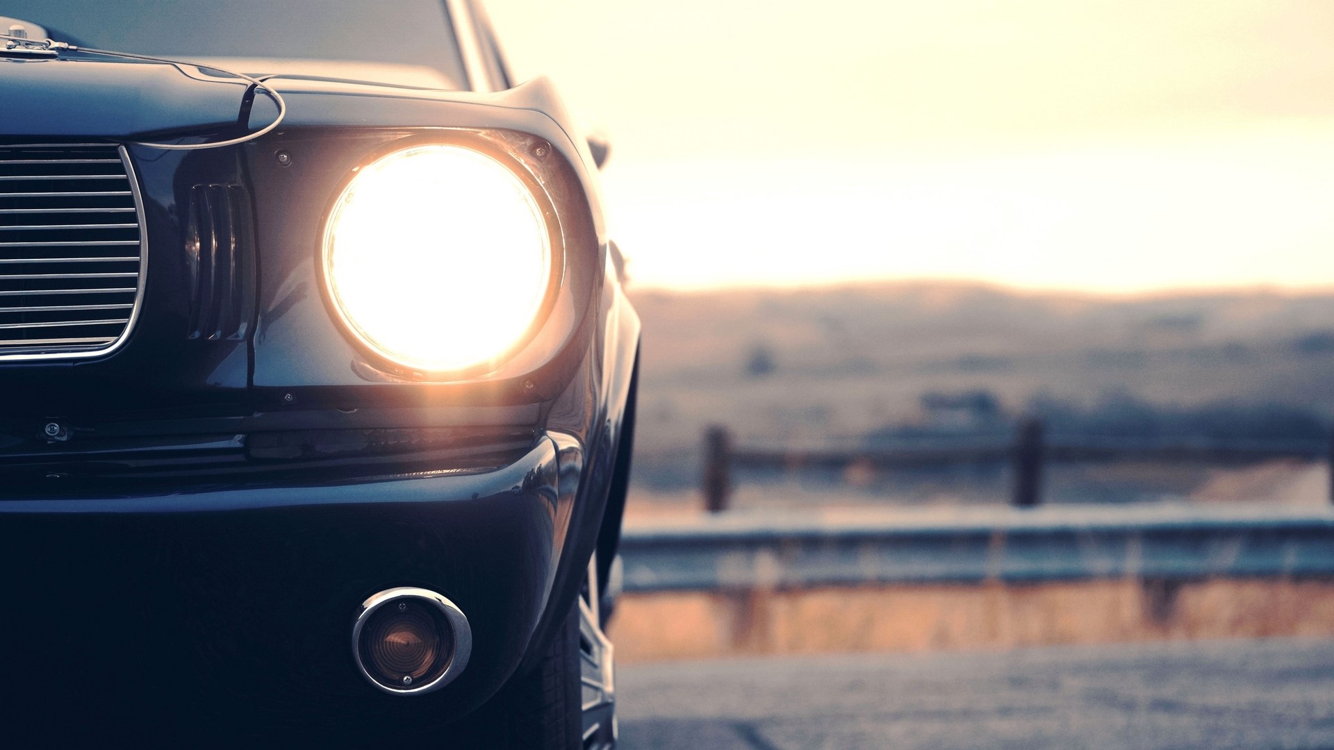 Close-up of a vintage car headlight at sunset HD Wallpaper