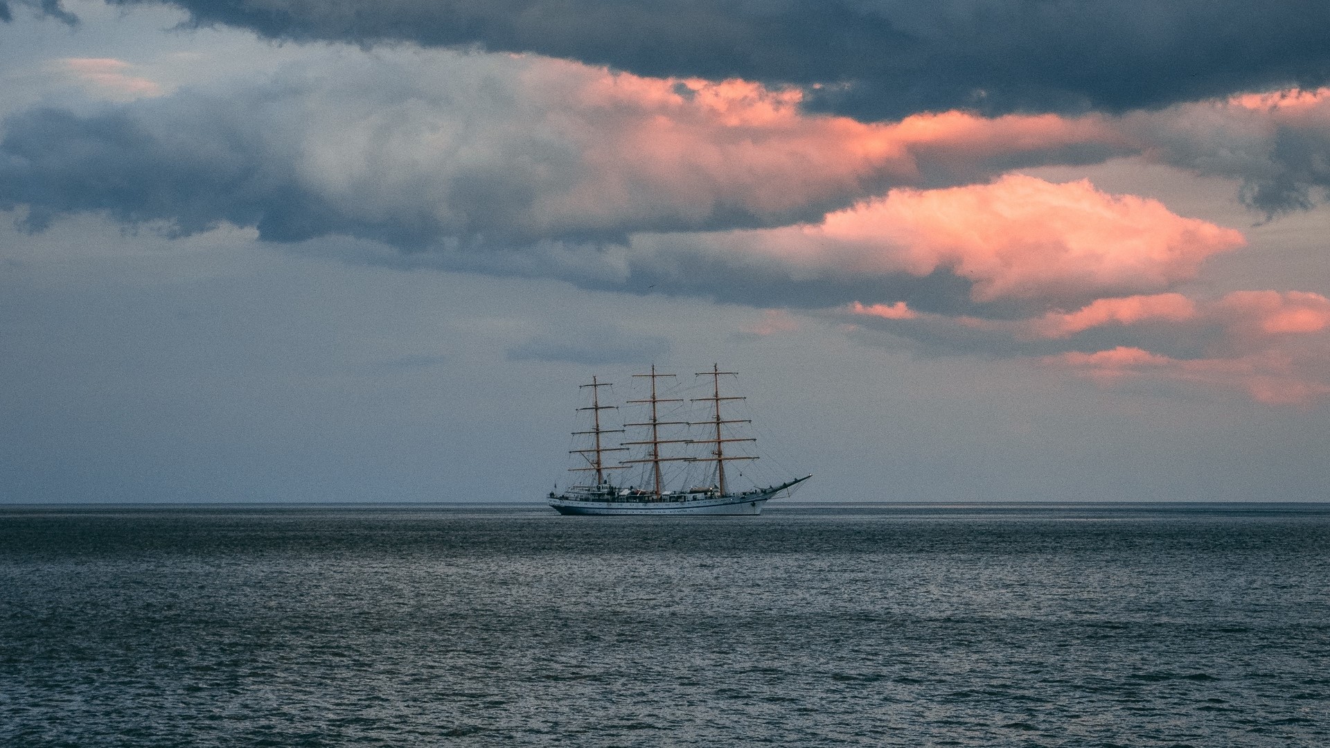 Tall ship sailing on the ocean at sunset HD Wallpaper