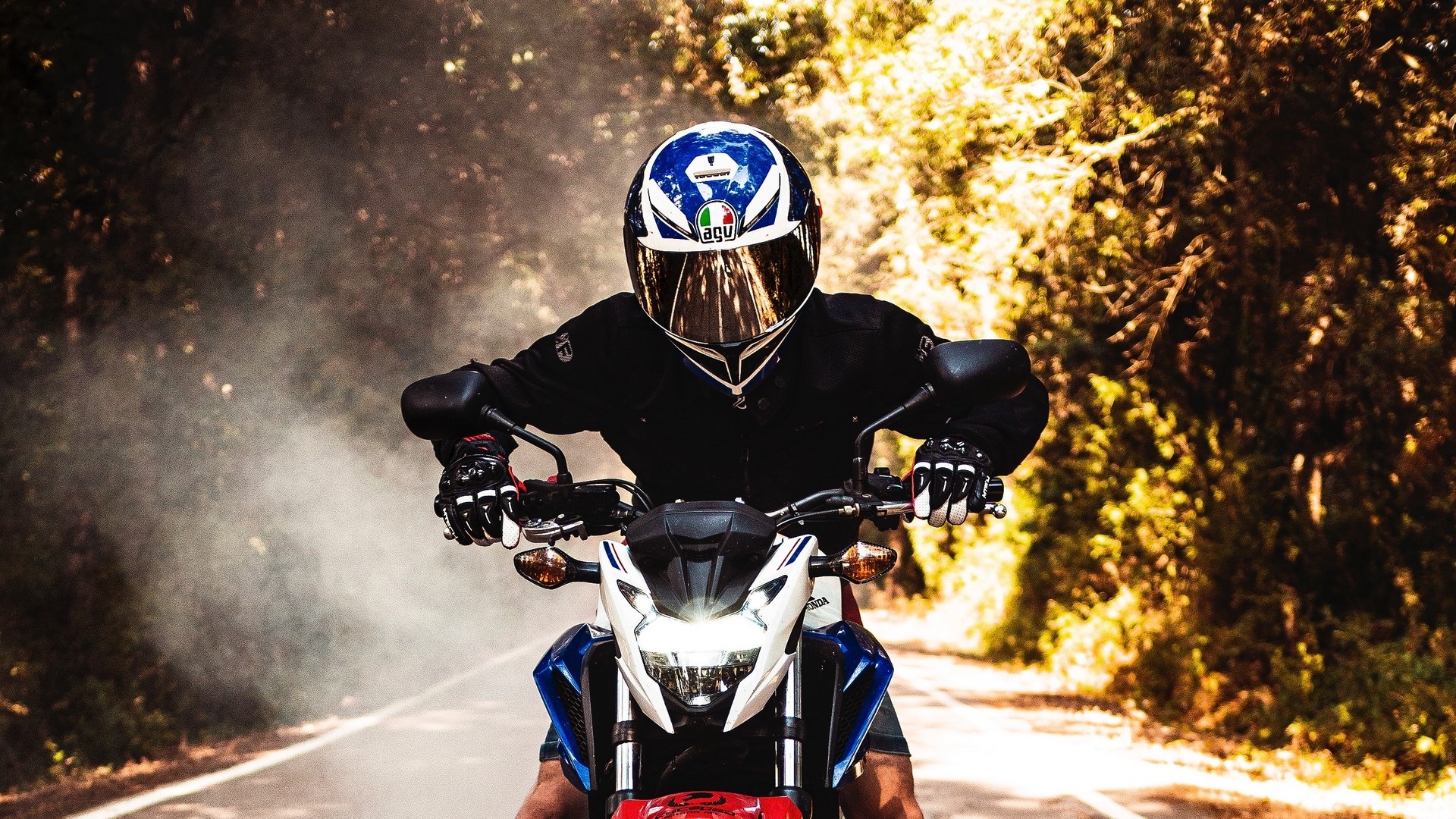 Motorcyclist wearing AGV helmet riding a motorcycle HD Wallpaper