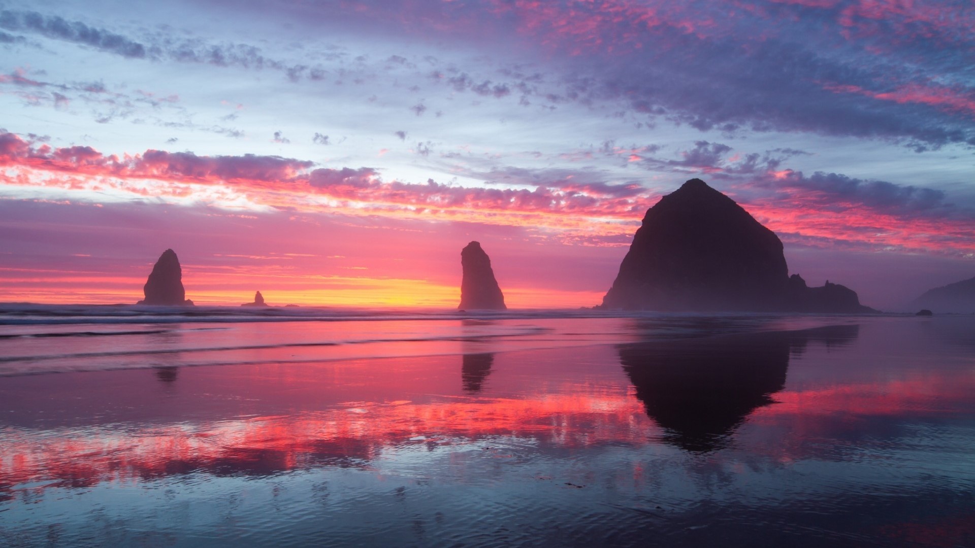 Sea stacks and colorful sunset reflection on beach HD Wallpaper