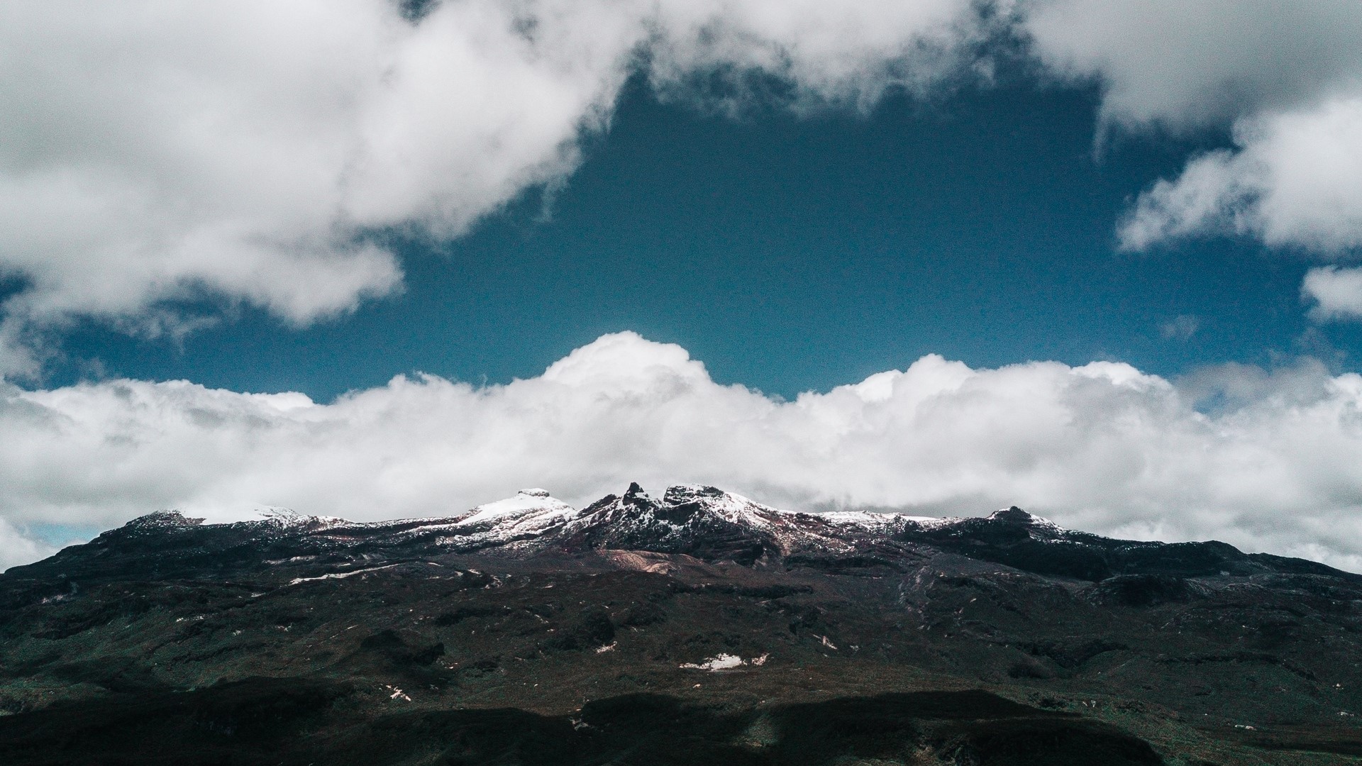 Snow-capped mountains under a blue sky with clouds HD Wallpaper