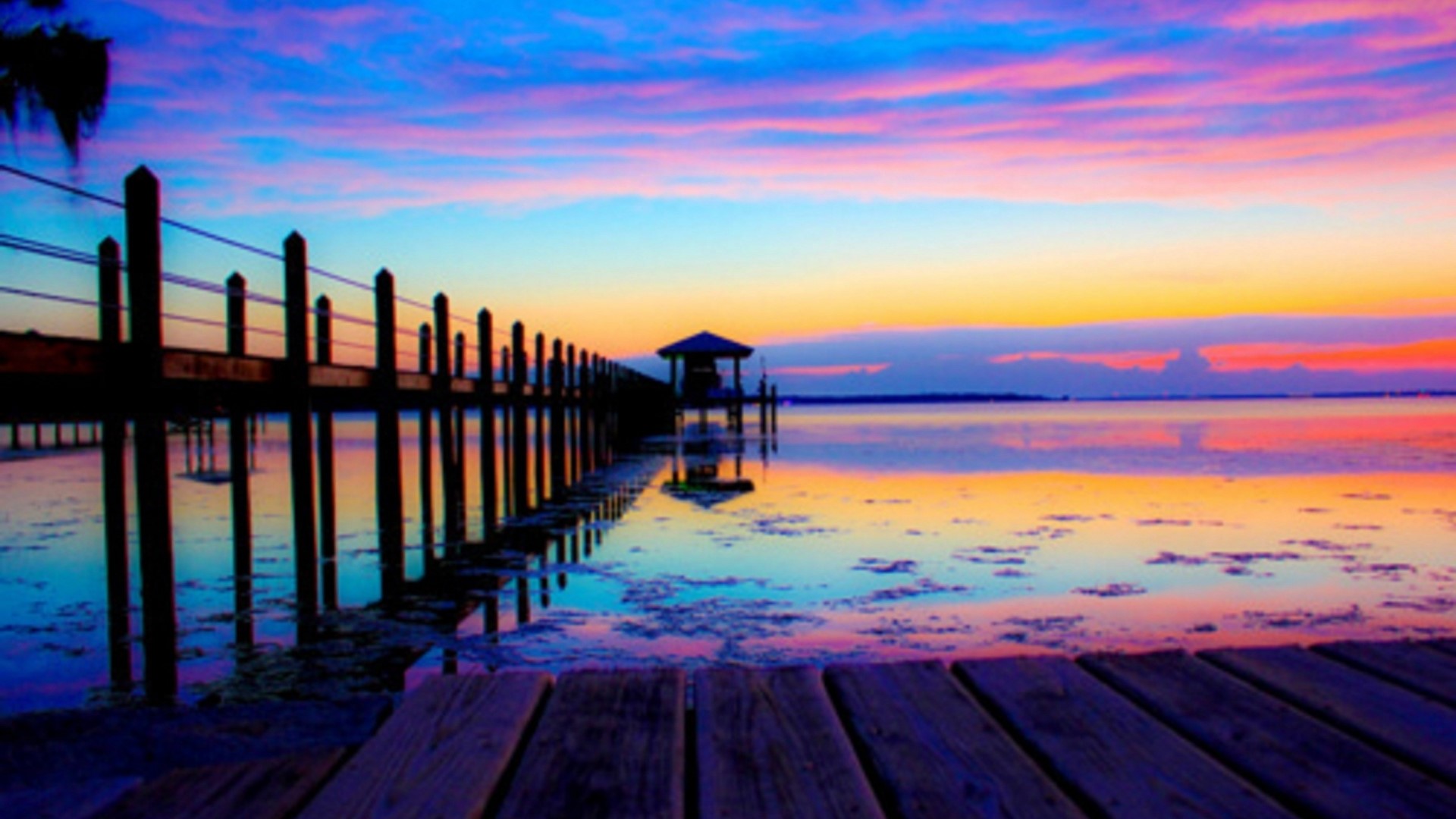 Dock and gazebo at sunset over water HD Wallpaper