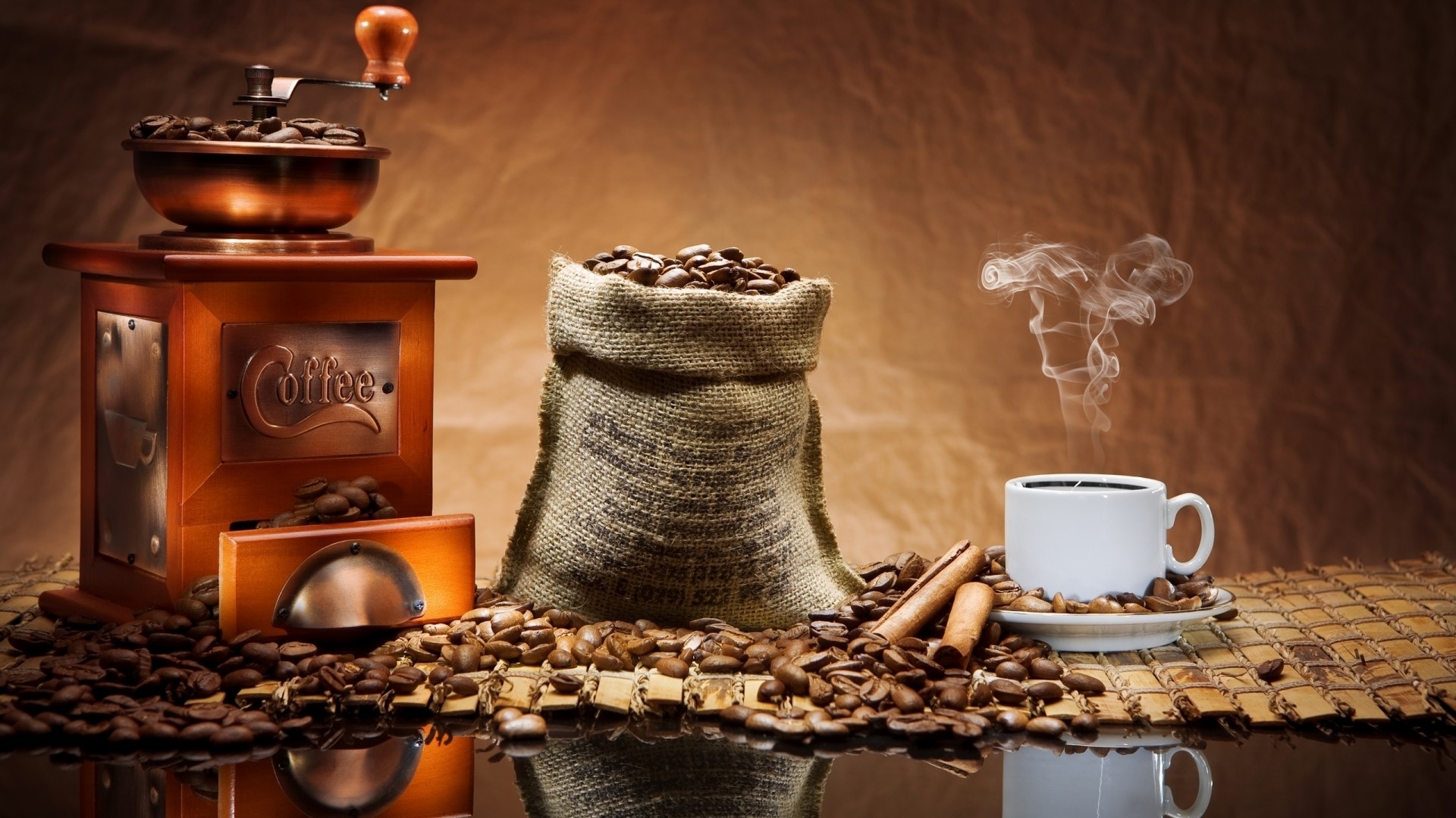 Coffee grinder, burlap sack of beans, and steaming cup of coffee HD Wallpaper