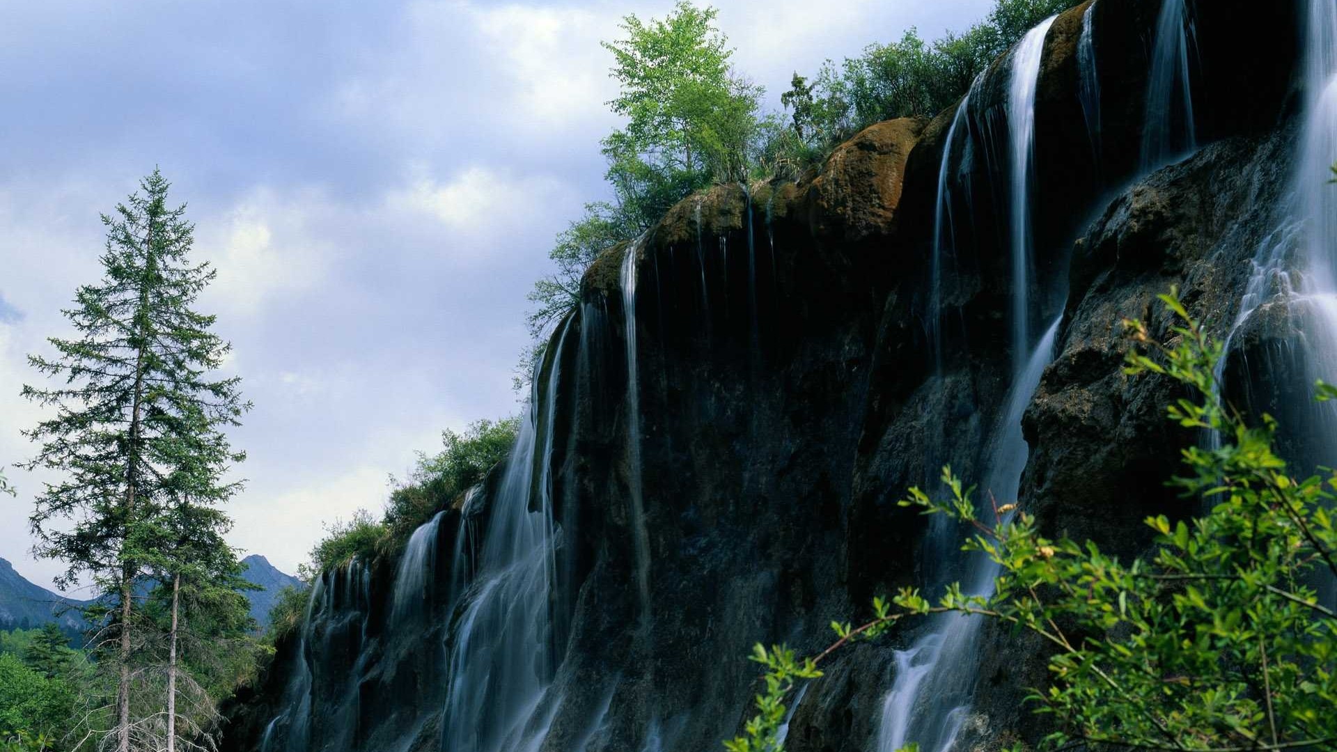 Mountain waterfall with trees and sky HD Wallpaper
