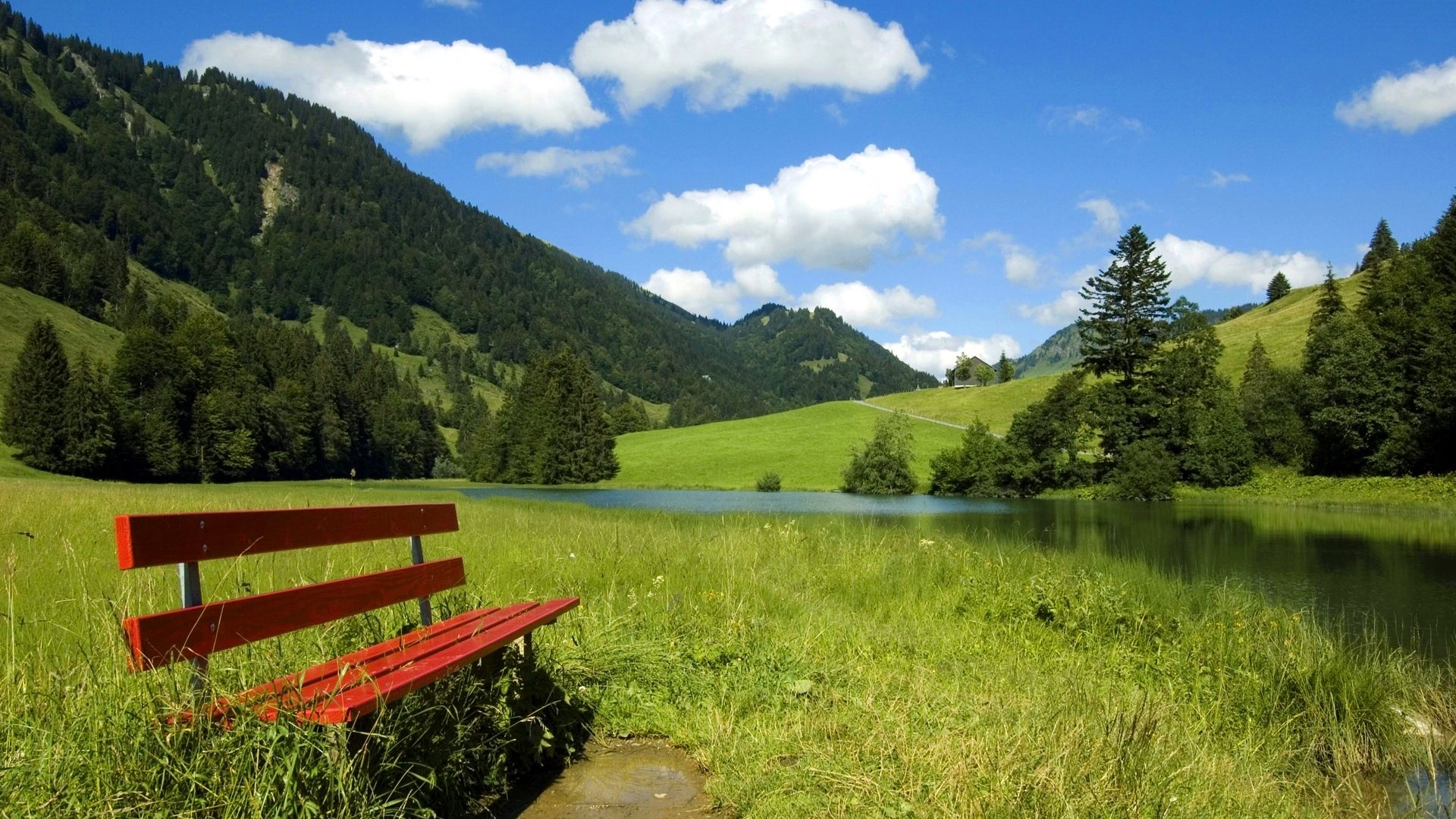 Red bench by a lake in the mountains HD Wallpaper