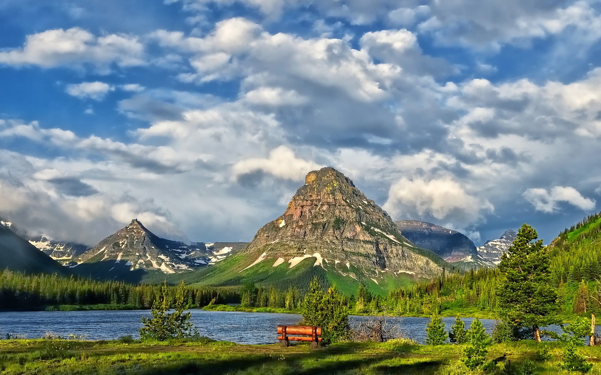 Mountain lake with bench and cloudy sky HD Wallpaper
