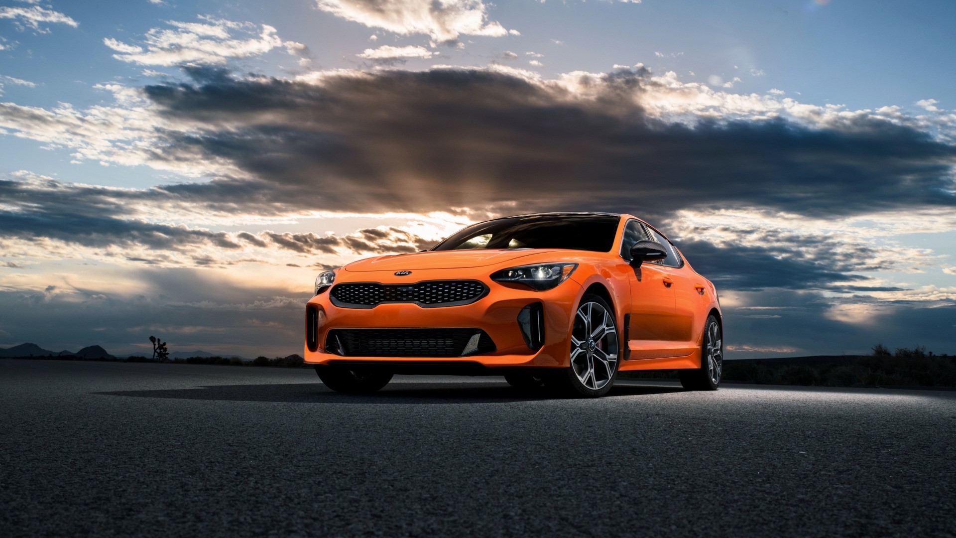 Orange Kia Stinger on Asphalt Road HD Wallpaper