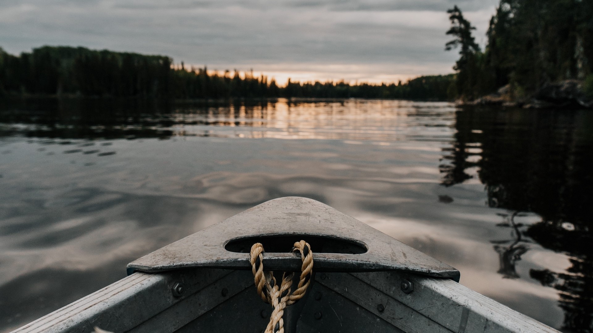 Boat on a lake at sunset HD Wallpaper